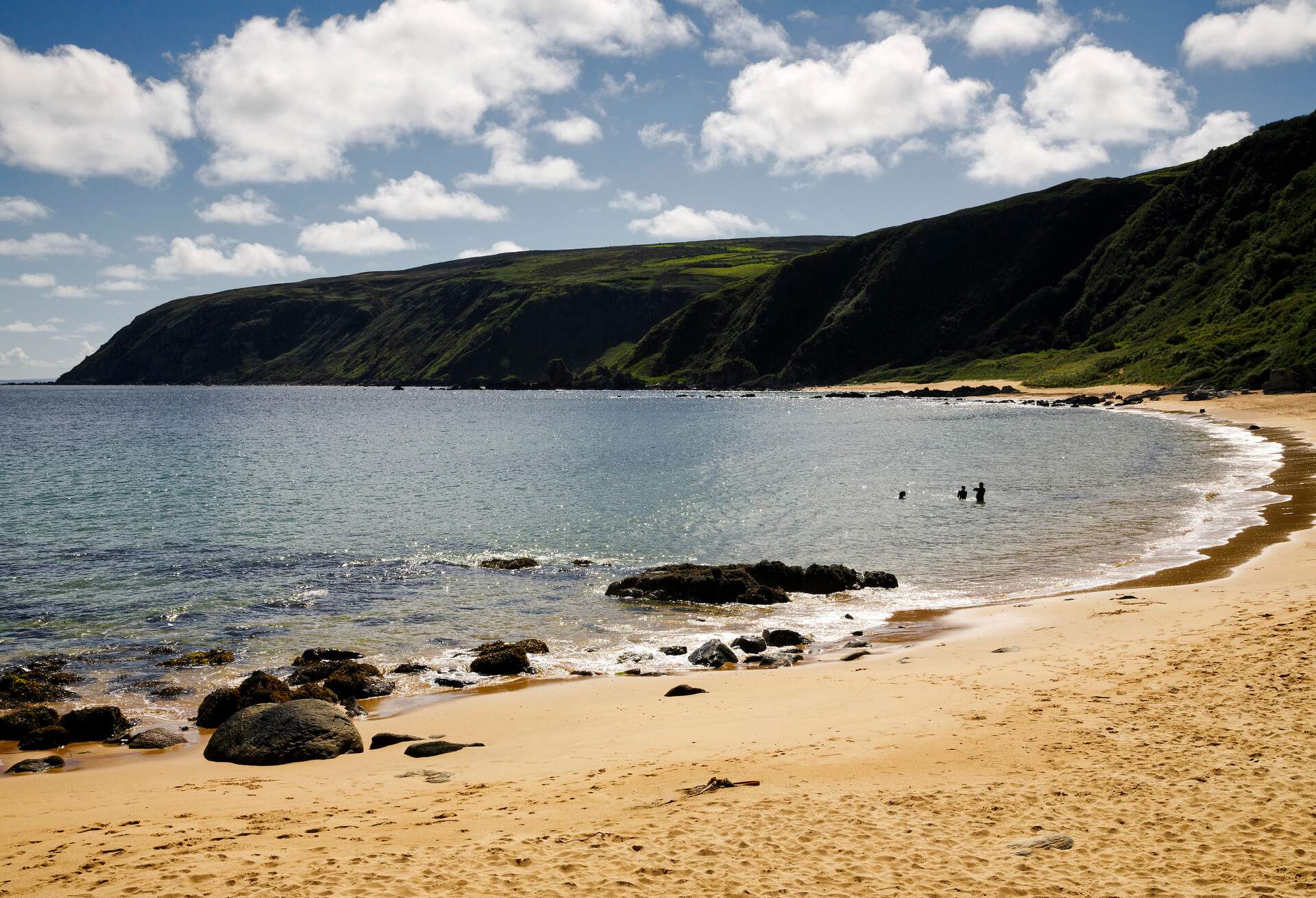 Kinnagoe Bay Beach is located on the Inishowen Peninsula in County Donegal. Access to the beach by a small winding road leading down through a casting cliff (Co. Donegal, Ireland).