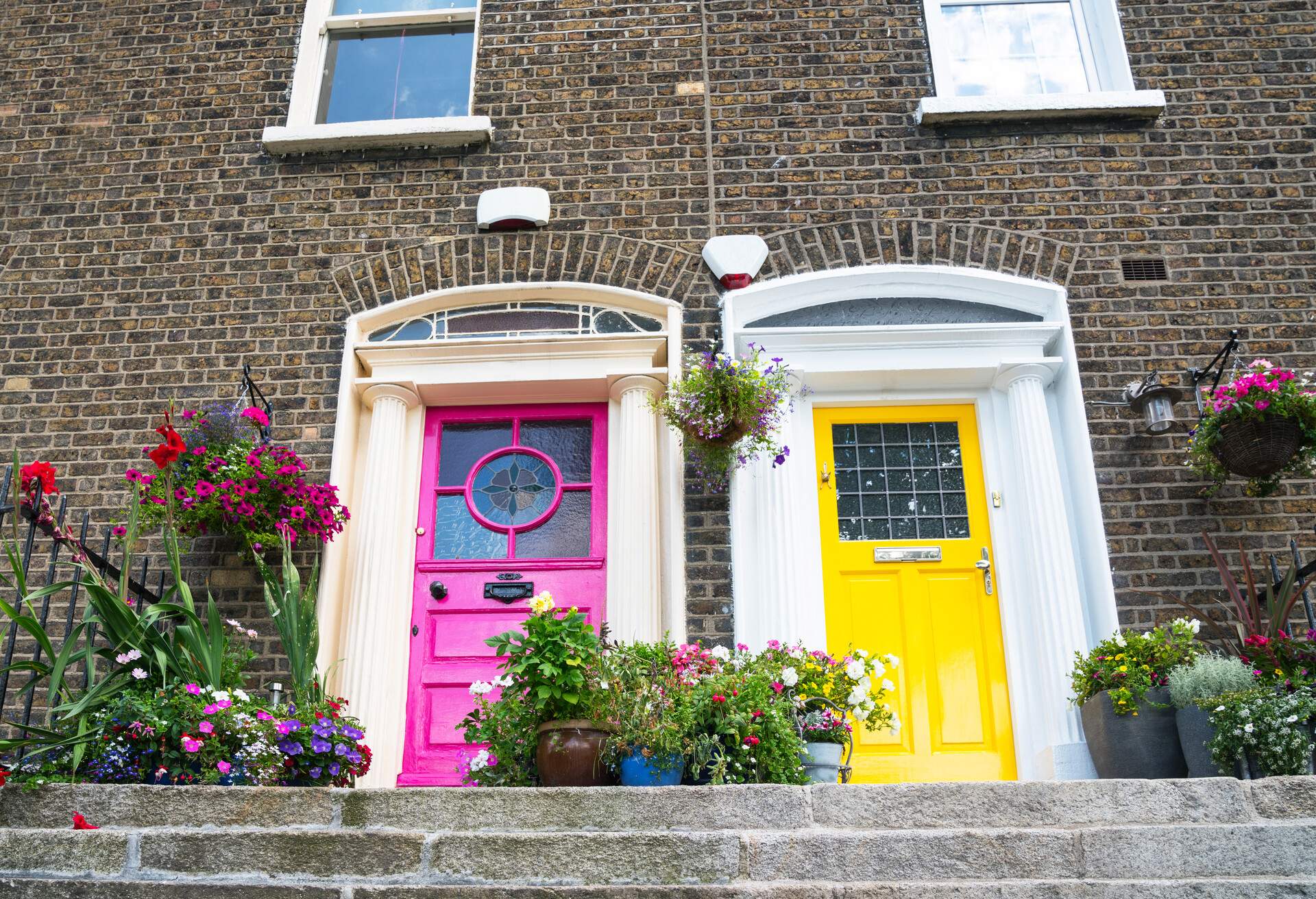 Step lead to colorful terrace houses exterior two doors