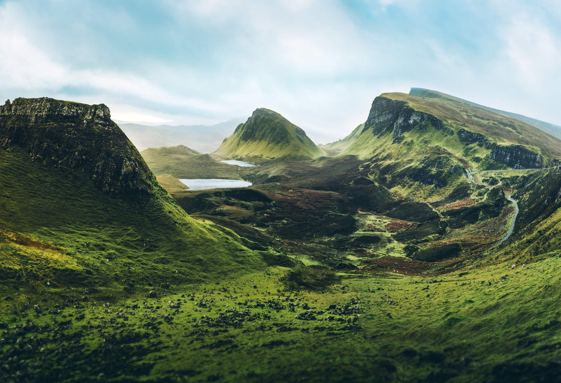 Also referred to as The Quiraing or Cuith-Raing is a landslip on the eastern face of Meall na Suiramach, the northernmost summit of the Trotternish or Tròndairnis (Scottish Gaelic) on the Isle of Skye, Scotland. ..Taken in dramatic December weather, the stormy ephemeral light opens and beams of short lived godrays radiate down over the spiked land formation called The Cleat, Loch Cleat, and Loch Leum na Luirginn below. The highest ridge to the right is called Dun Dubh, and the interesting craggy dinosaur back - shark fin formation on the lower right is called Cnoc a Mheirlich.