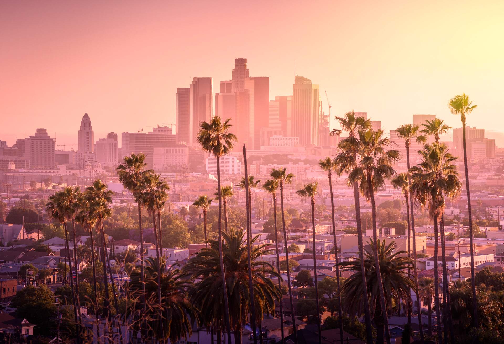DEST_USA_CALIFORNIA_LOS-ANGELES_SKYLINE_SUNSET_PALM-TREES_TONED_GettyImages-802758686