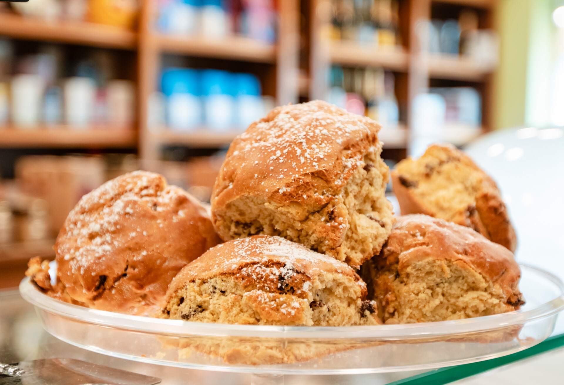 different freshly made pastries displayed in cafe bakery fridge, ready for sale or eating