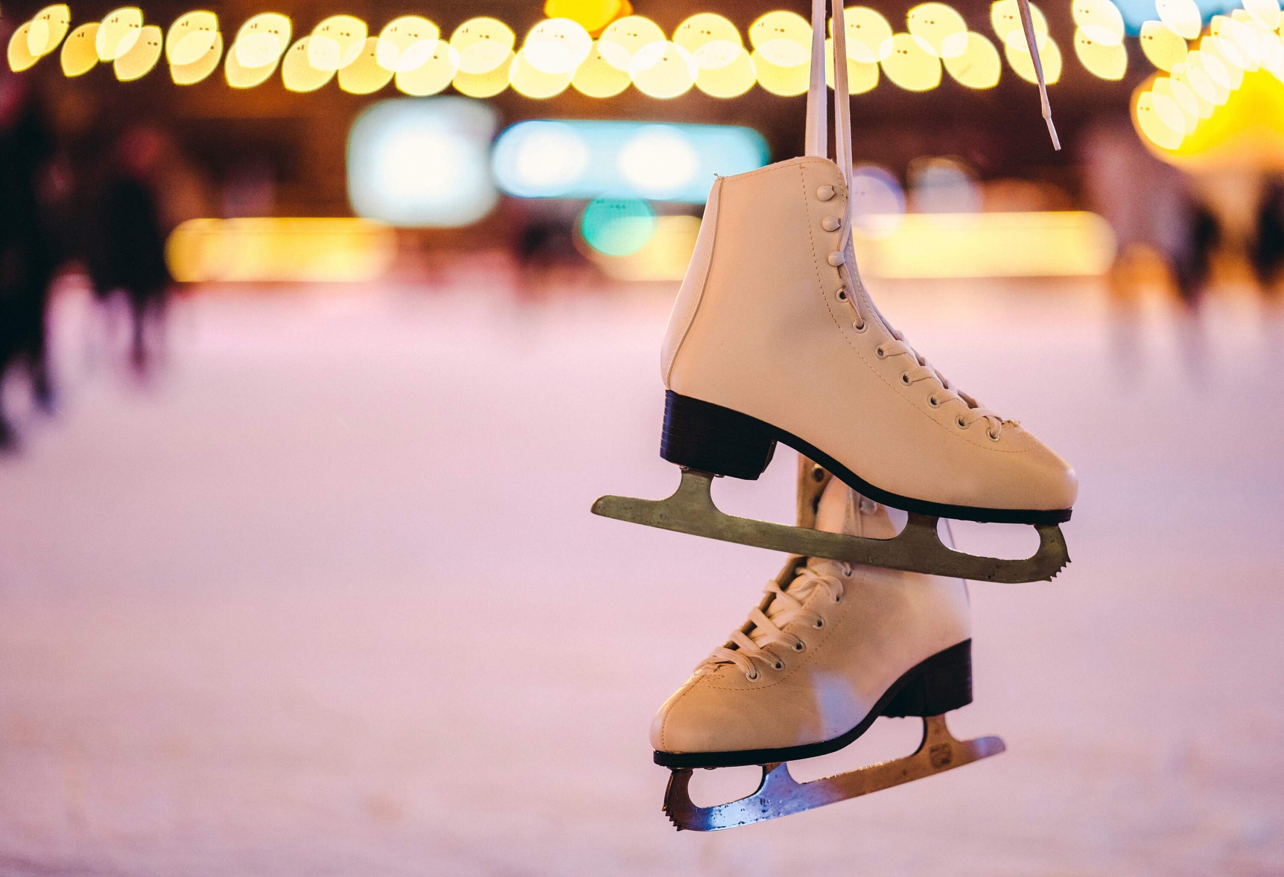 A pair of ice rink skates hung on top of each other.