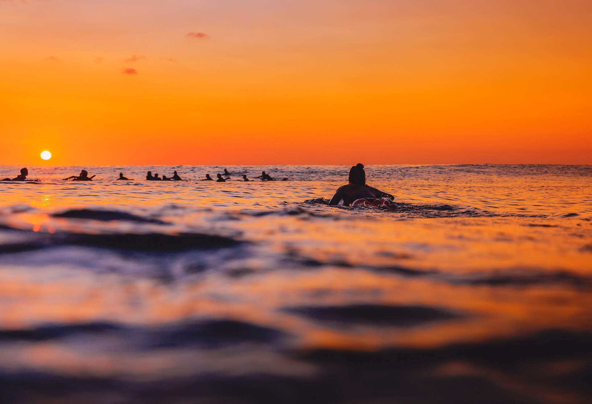 THEME_PEOPLE_WOMAN_SURFER_SEA_SUNSET_GettyImages-1059527132