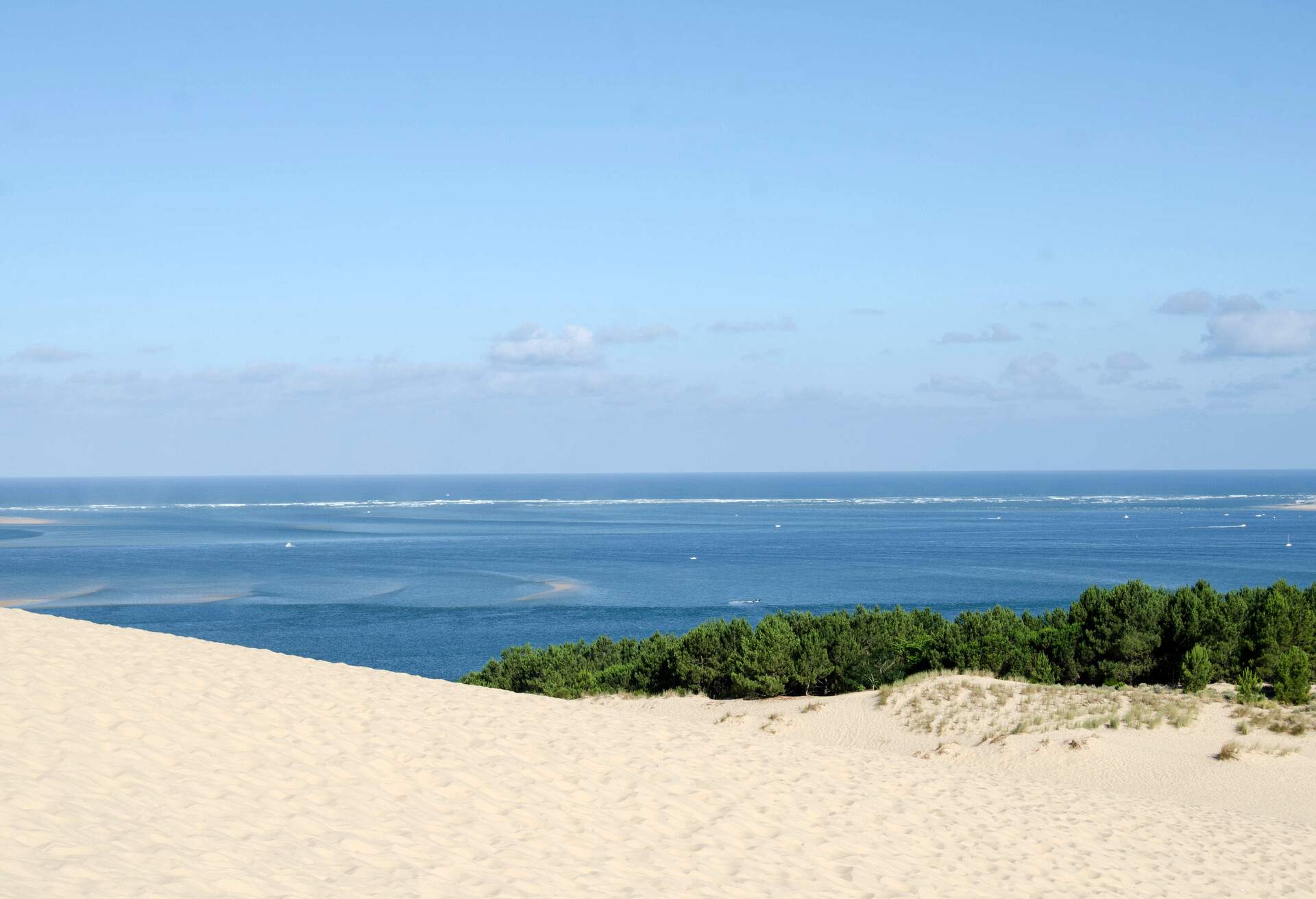The Dune of Pilat (French: Dune du Pilat, official name), also called Grande Dune du Pilat) is the tallest sand dune in Europe. It is located in La Teste-de-Buch in the Arcachon Bay area, France, 60 km from Bordeaux...The dune has a volume of about 60,000,000 m³, measuring around 500 m wide from east to west and 2.7 km in length from north to south. Its height is currently 110 meters above sea level. The dune is a famous tourist destination with more than one million visitors per year.