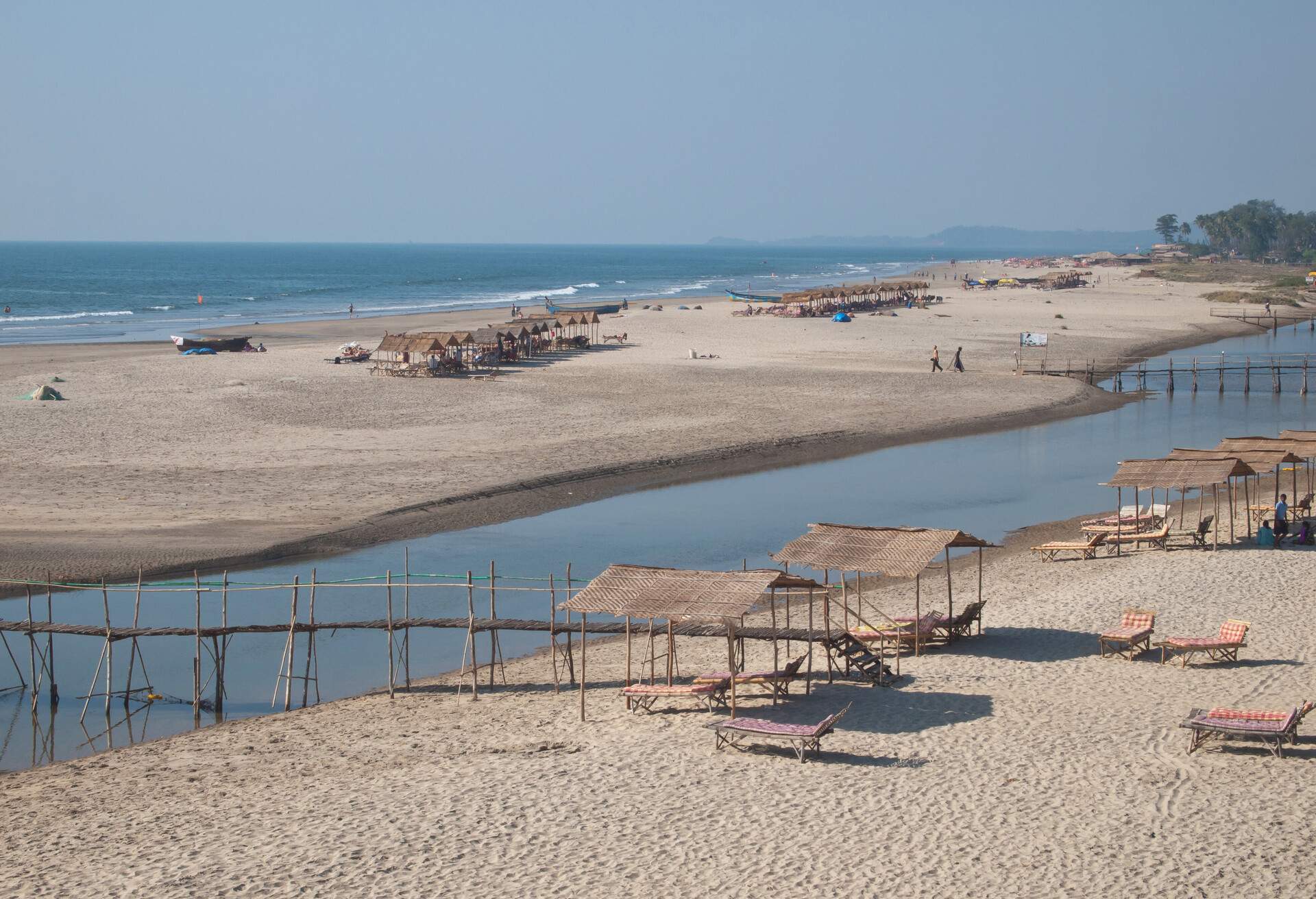 Mandrem Beach behind the Mandrem River in North Goa is a quiet and peaceful white sand beach with clear water.