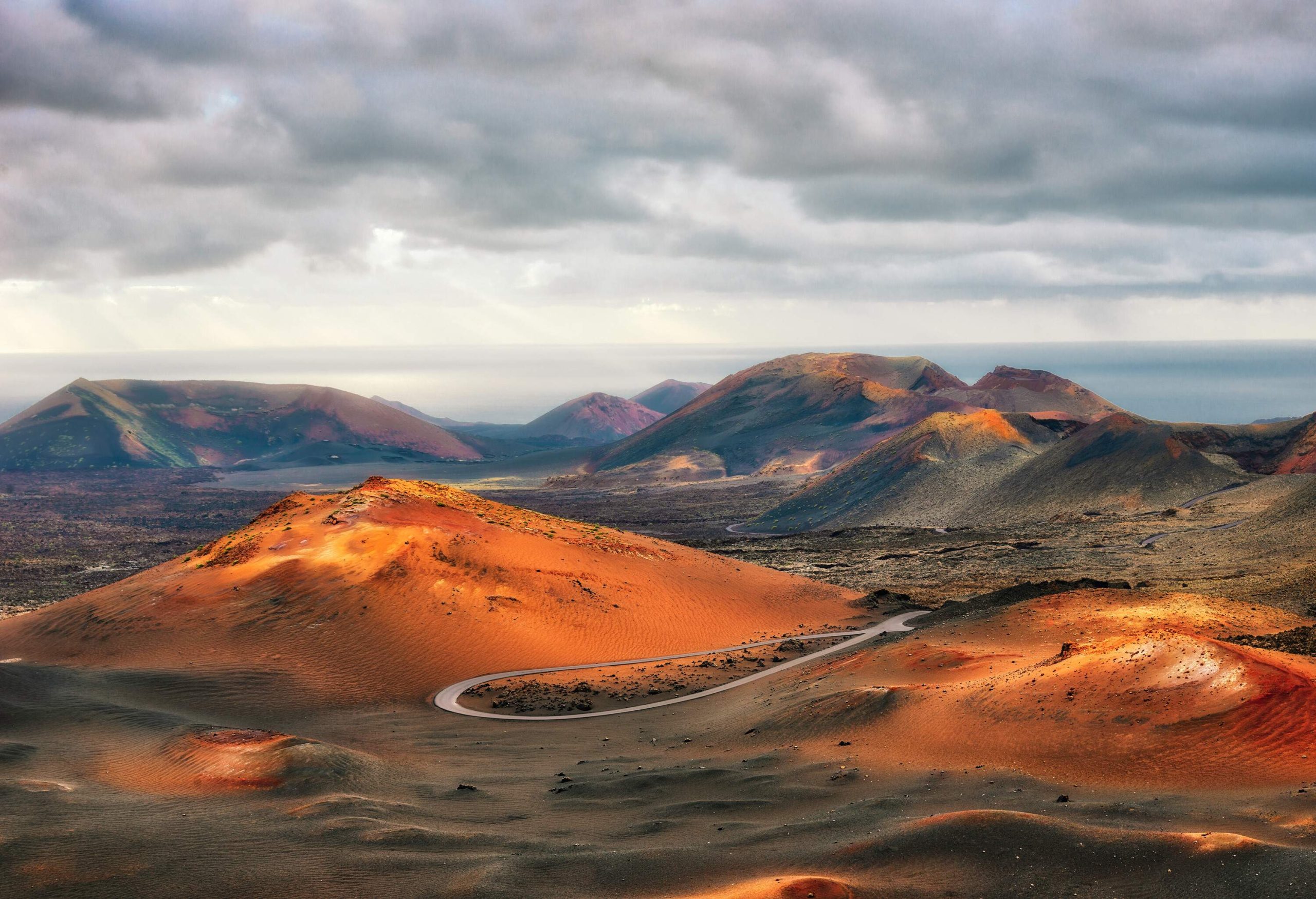 A curving highway between hills in a desolate landscape.