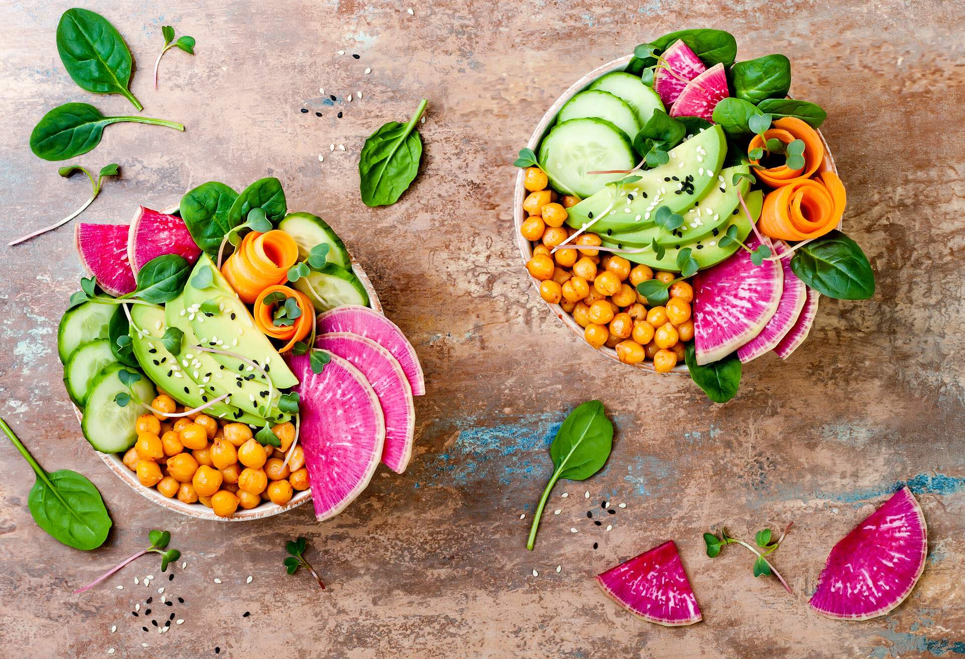 Vegan, detox Buddha bowl recipe with avocado, carrots, spinach, chickpeas and radishes. Top view, flat lay, copy space