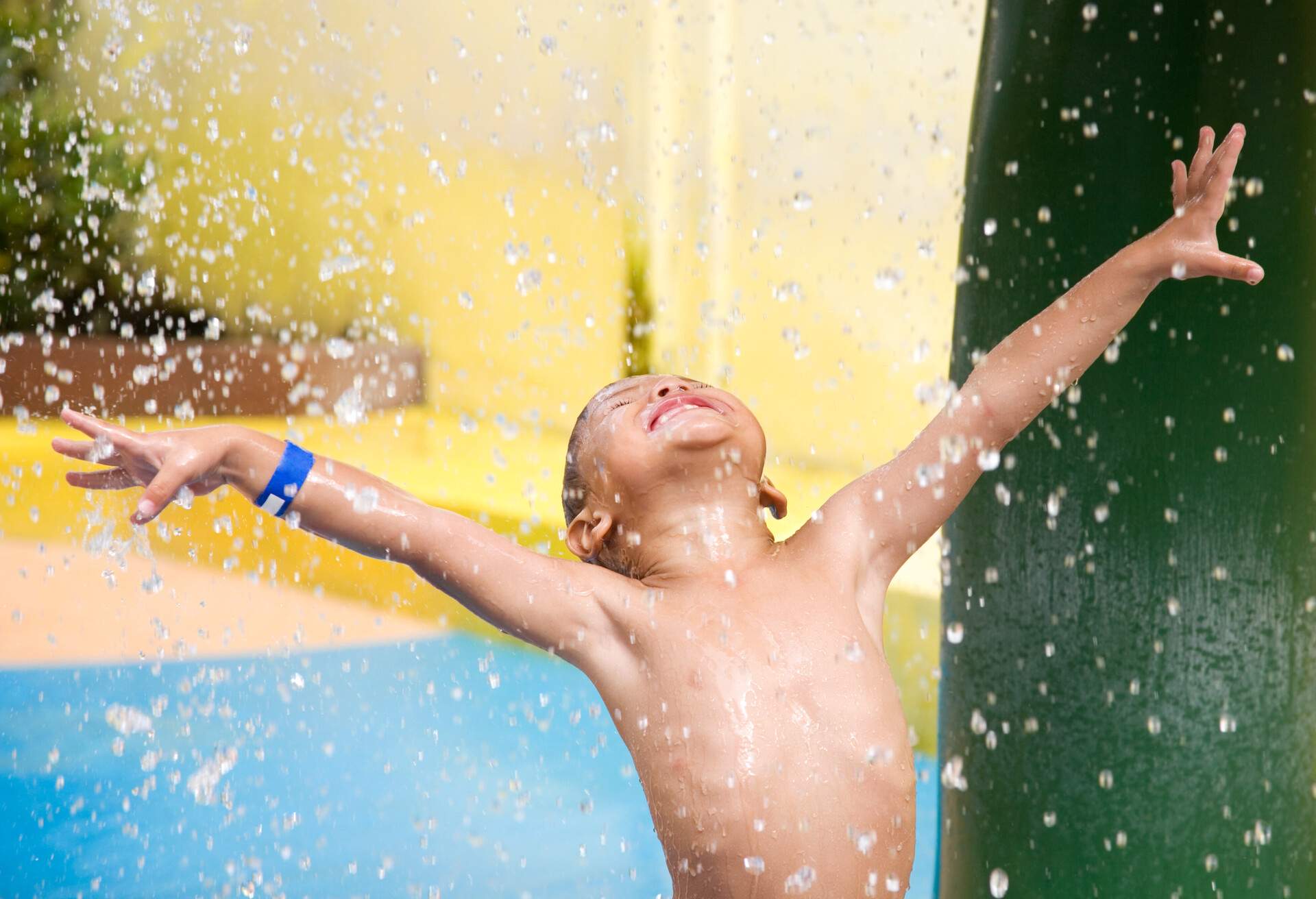 Child 3 years old enjoying in swimming pool