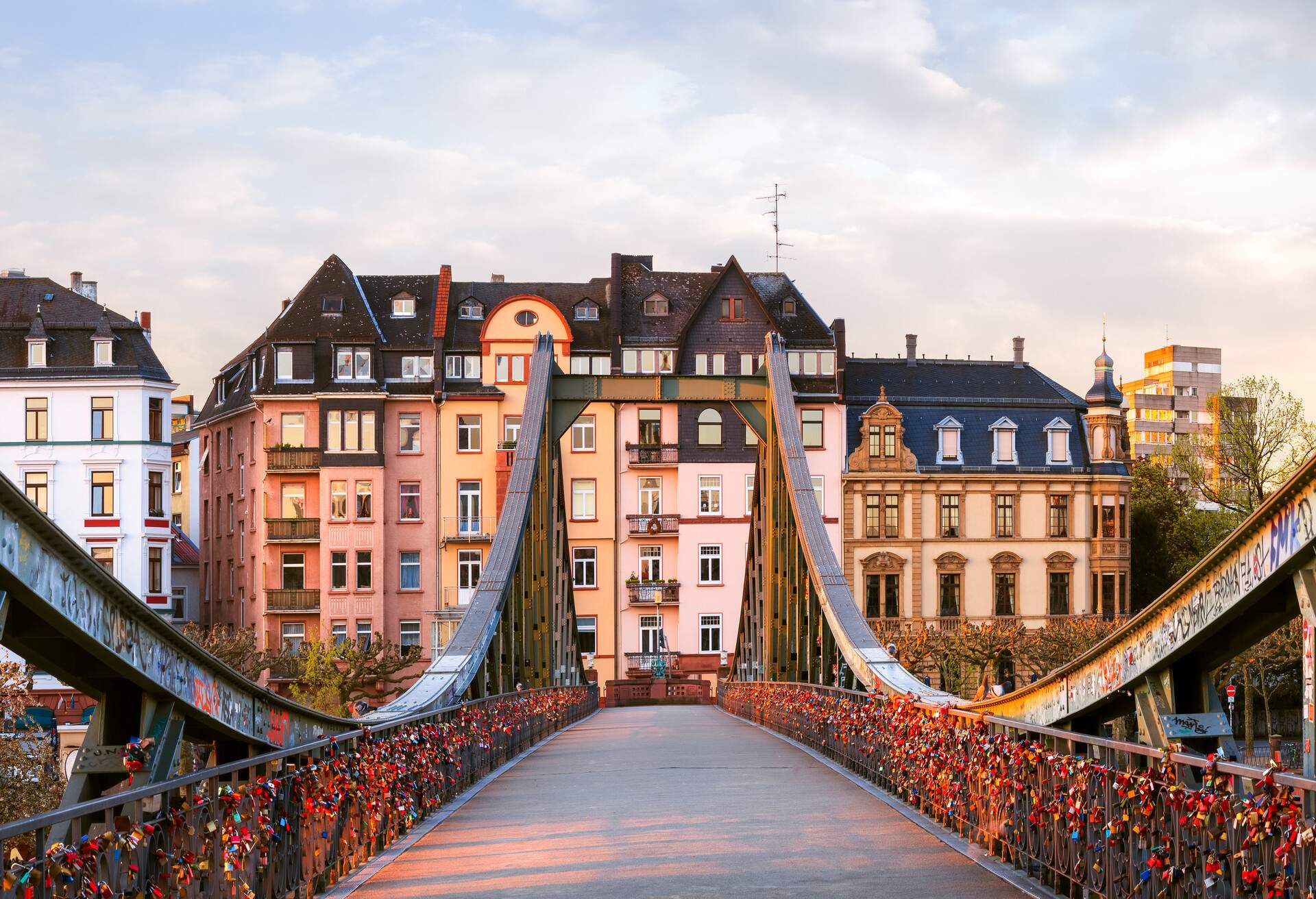 The Eiserner Steg (Iron Bridge), Frankfurt, Hessen, Germany - The footbridge crosses the River Main, it connects the centre of Frankfurt with the district of Sachsenhausen (built in 1868). The bridge was blown up in the final days of WWII, but was rebuilt shortly afterwards.