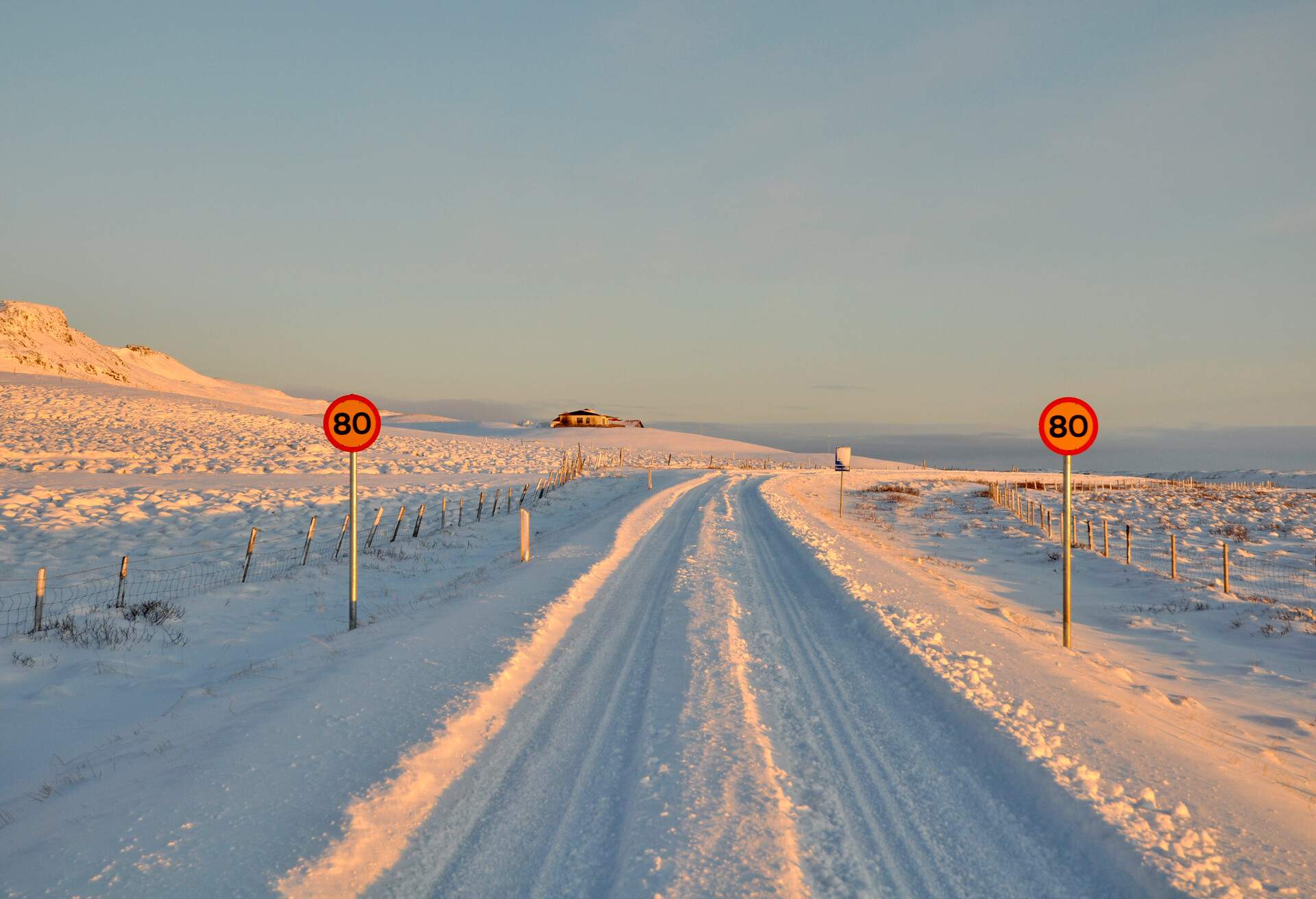Snowy covered road and Road sign near Stykkisholmur west Iceland. Stykkisholmur is a town and municipality situated in the western part of Iceland, in the northern part of the Snæfellsnes peninsula.