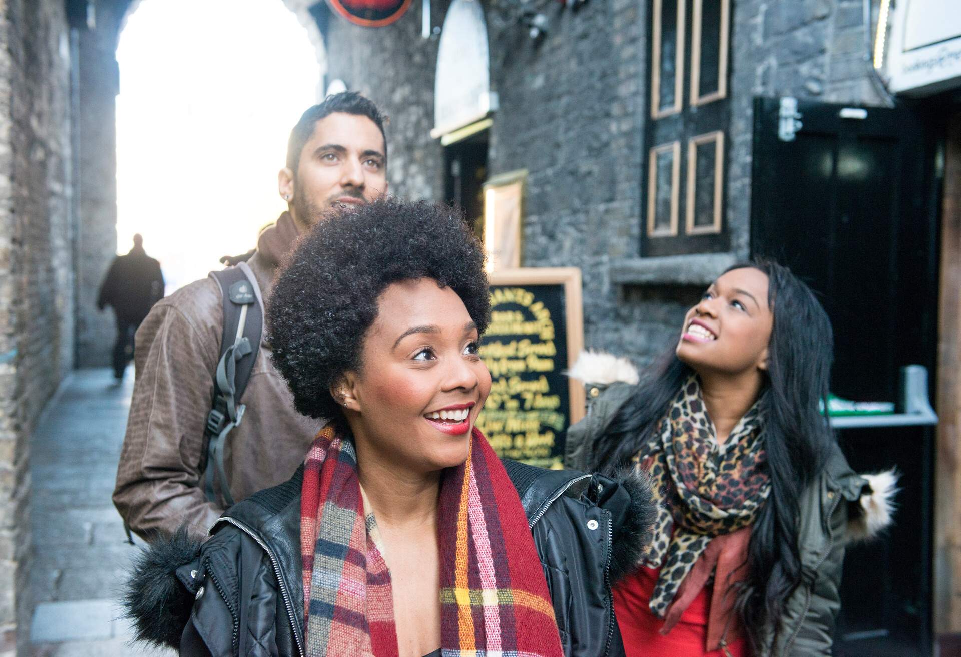 A group of tourists exploring Temple Bar, Dublin city centre, Ireland.