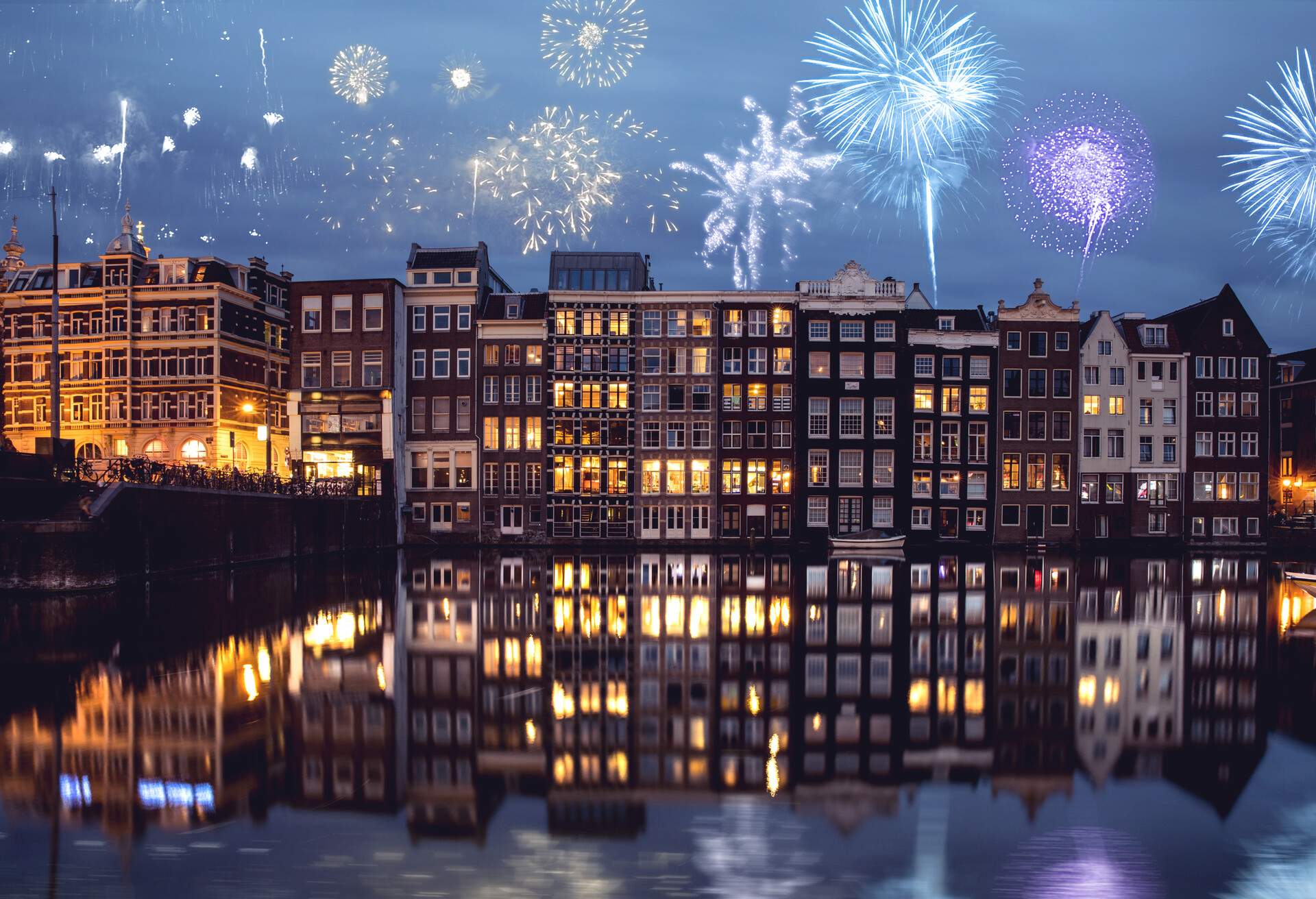 fireworks above the traditional narrow houses by the canals in Amsterdam