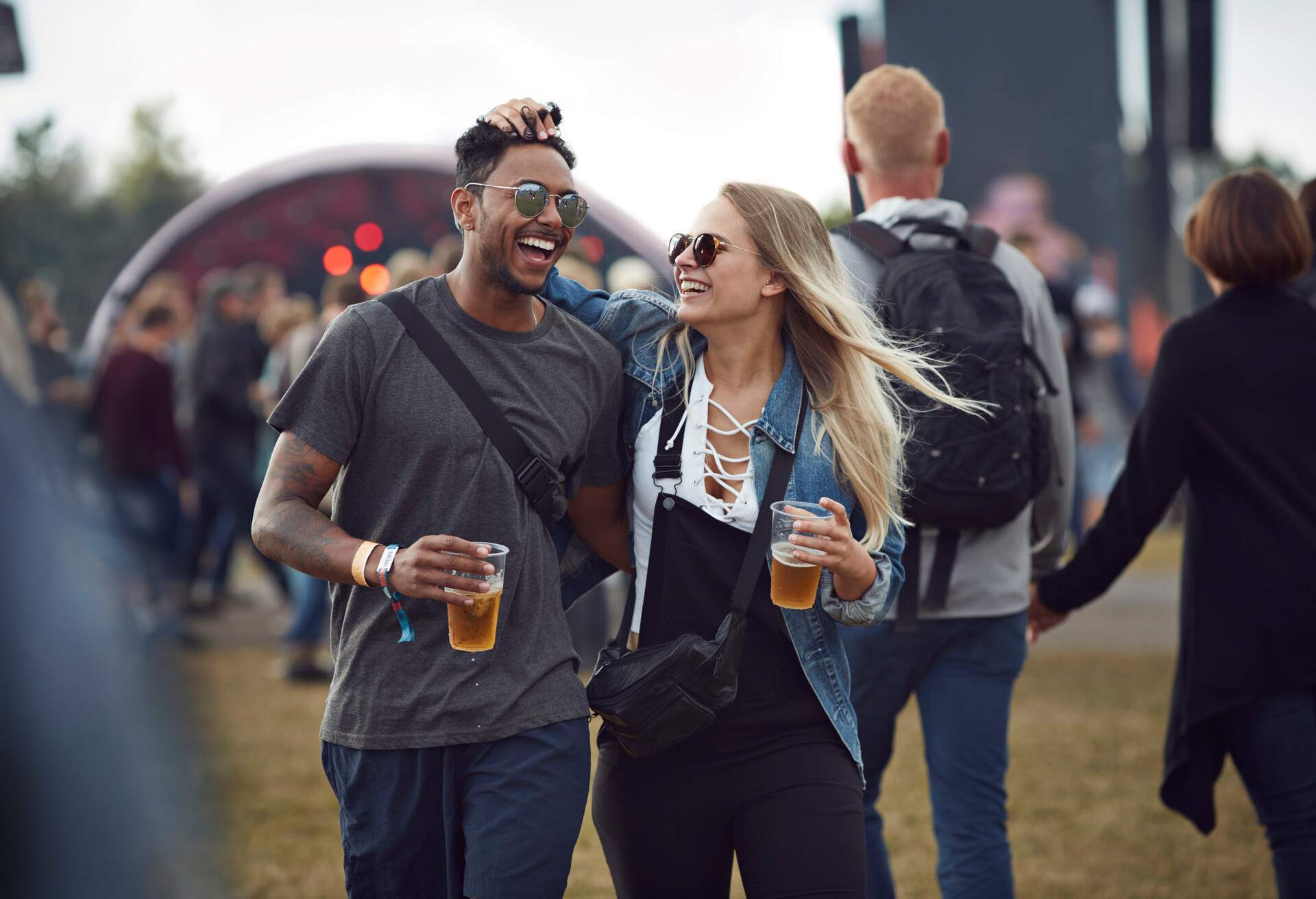 Friends hanging out at big music festival