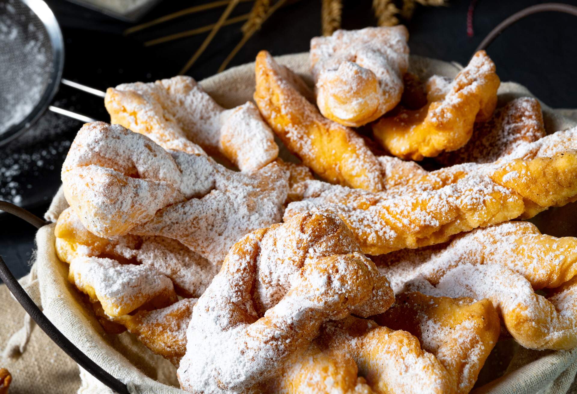A basket of traditional Polish lard pastry dusted with powdered sugar.