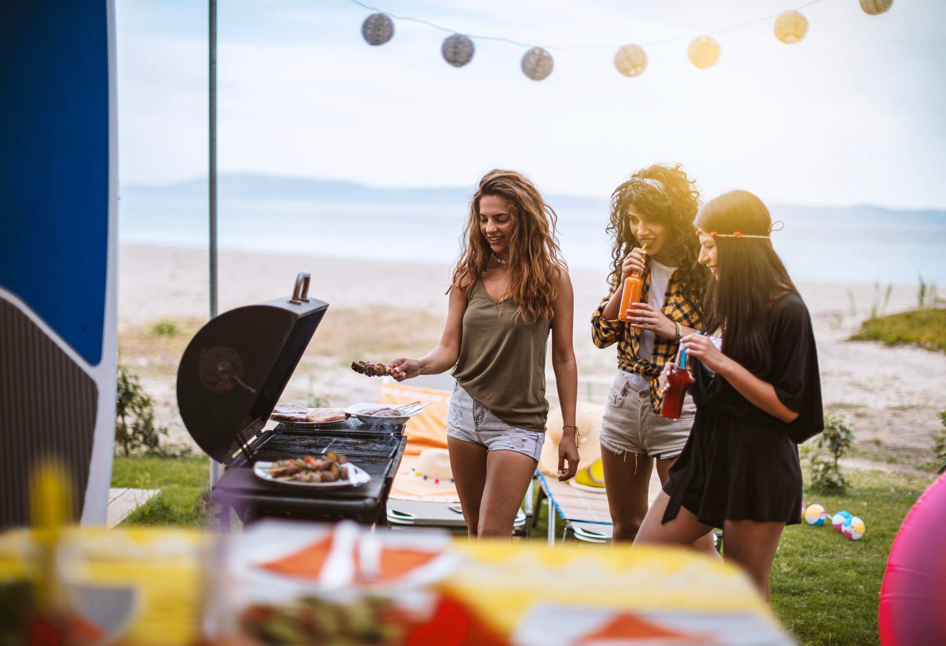 THEME_GLAMPING_CAMPING_BBQ_FRIENDS_GettyImages-1152136813