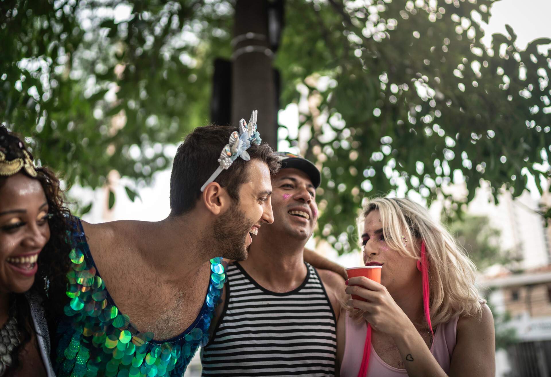 friends embracing each other have fun at a carnival party in Brazil