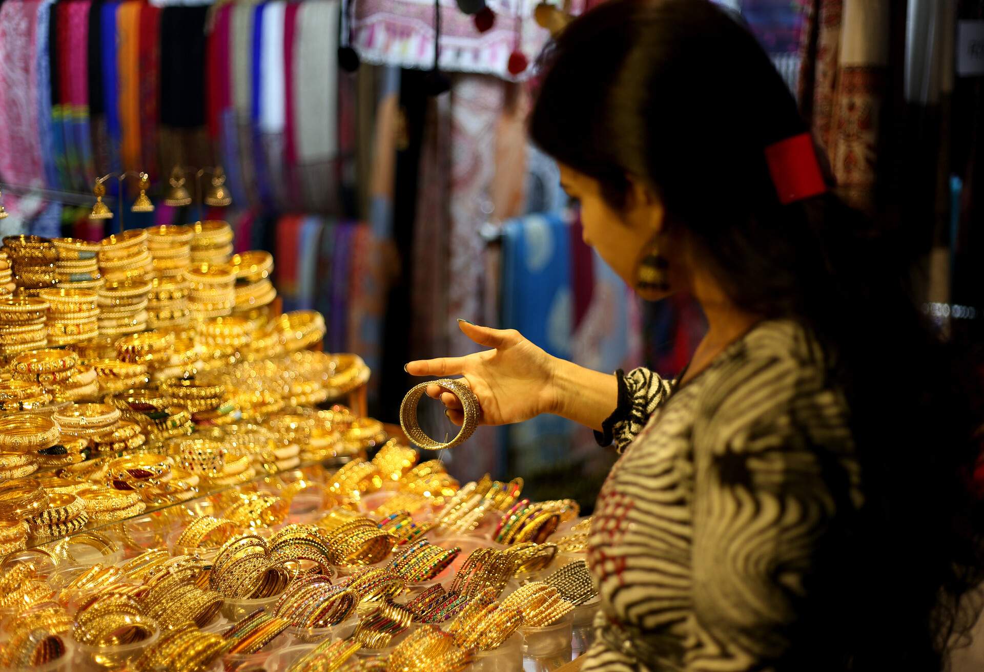 Young women choosing jewelry from jewelry shop in Meena Bazaar, Red Fort, Delhi, India.