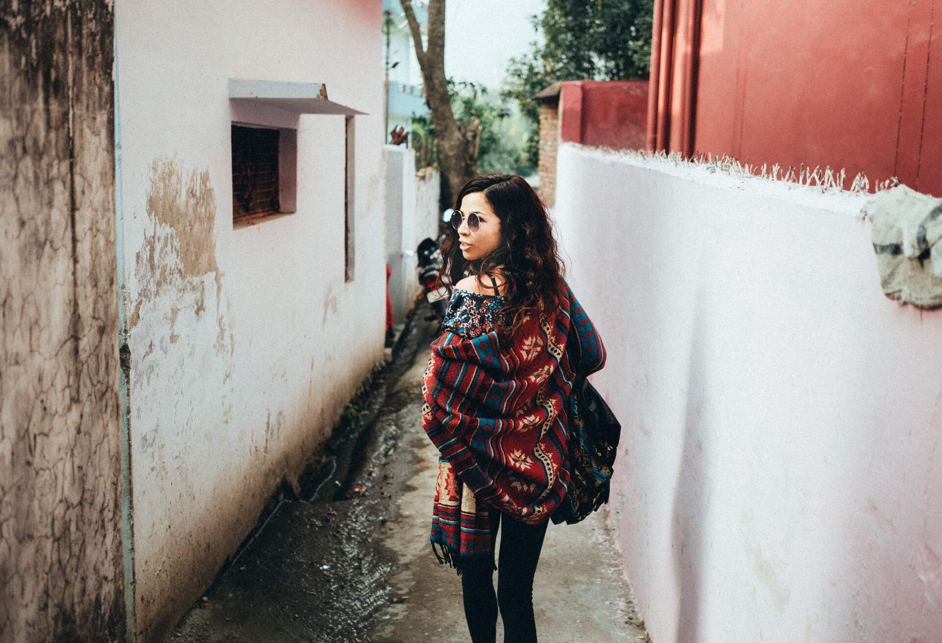 Young woman walking on the small street in Rishikesh, India