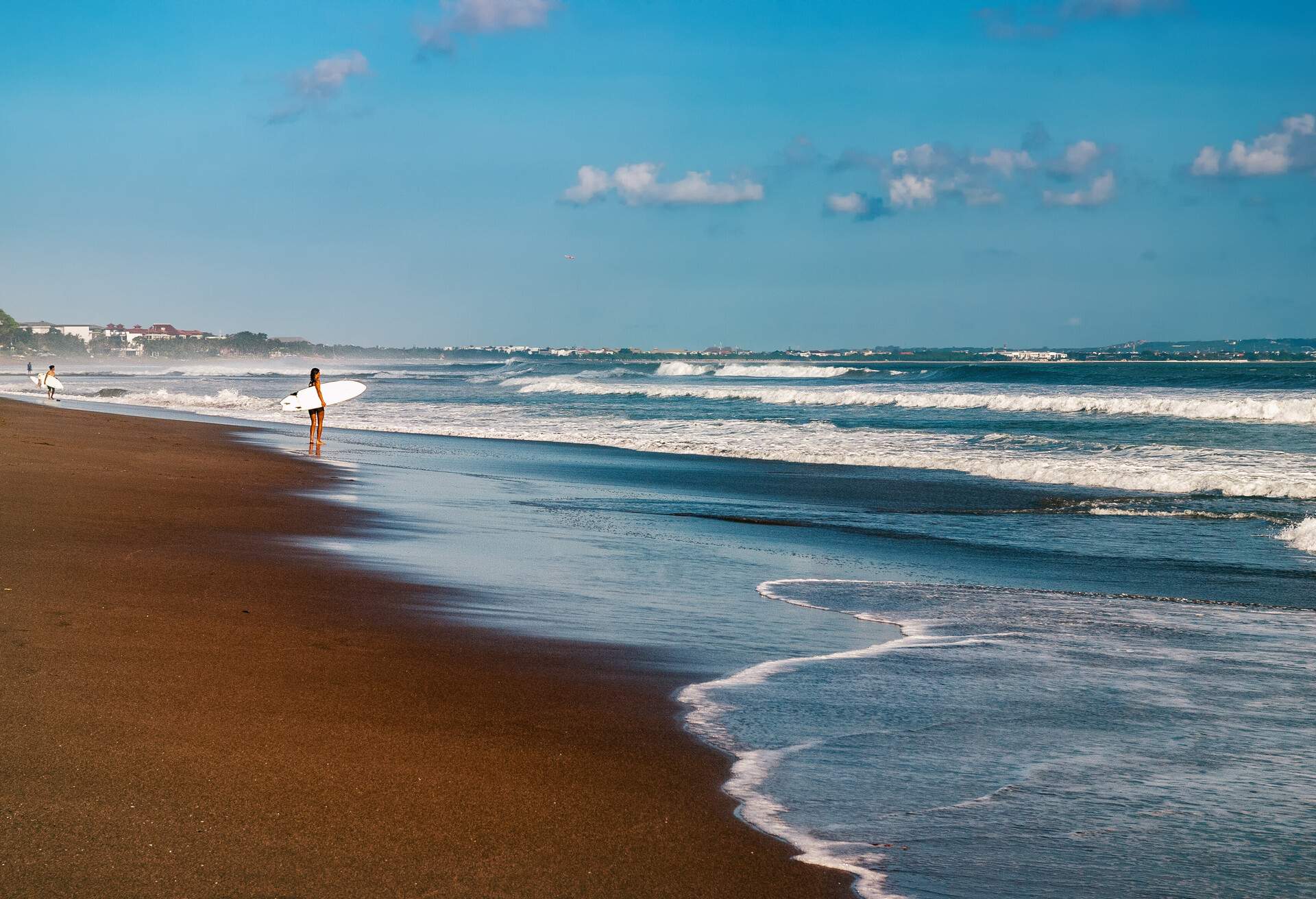 Surfer girl standing at beach in Canggu, Bali