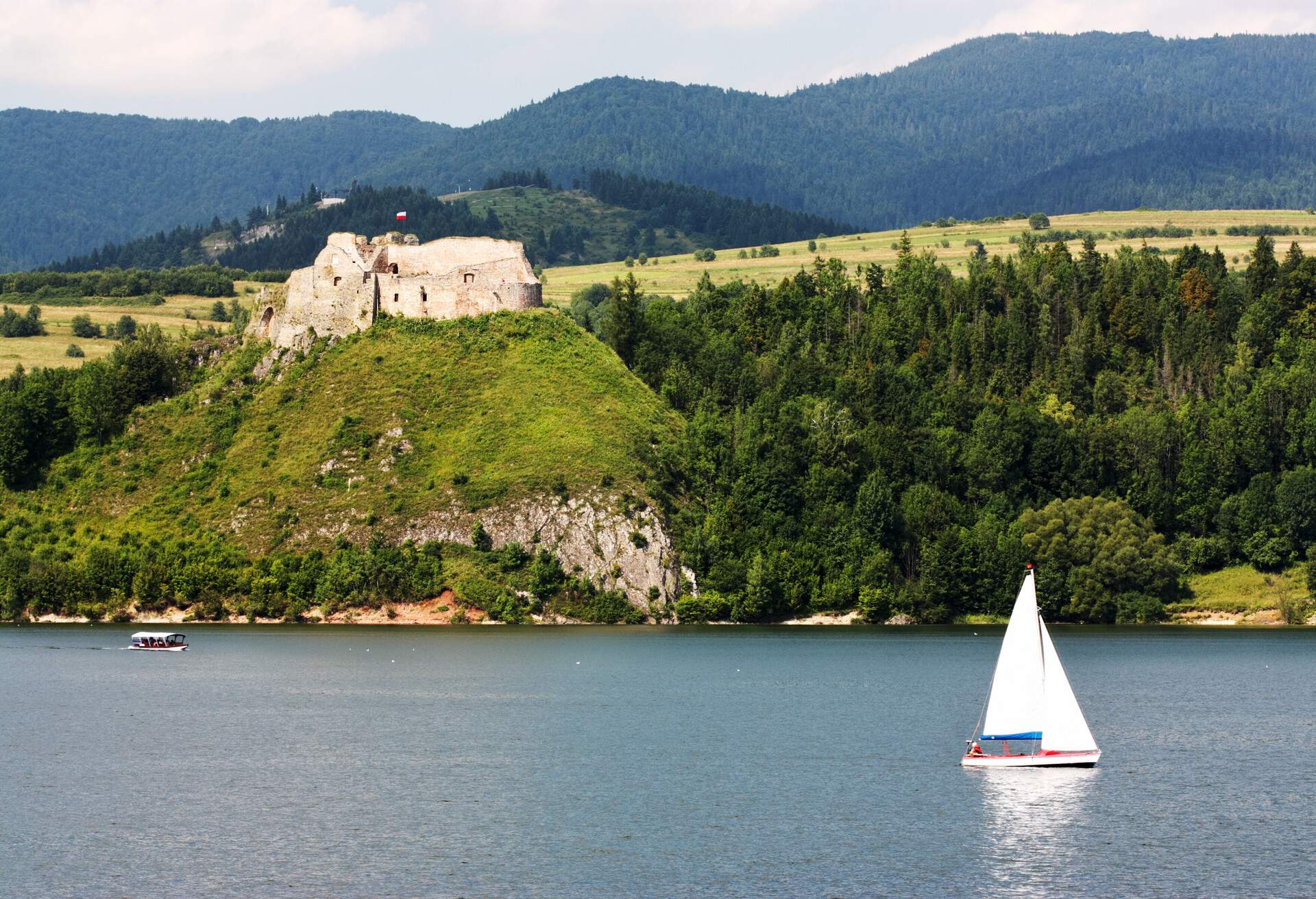 Medieval castle and sailboat. Czorsztyn Castle, Poland.