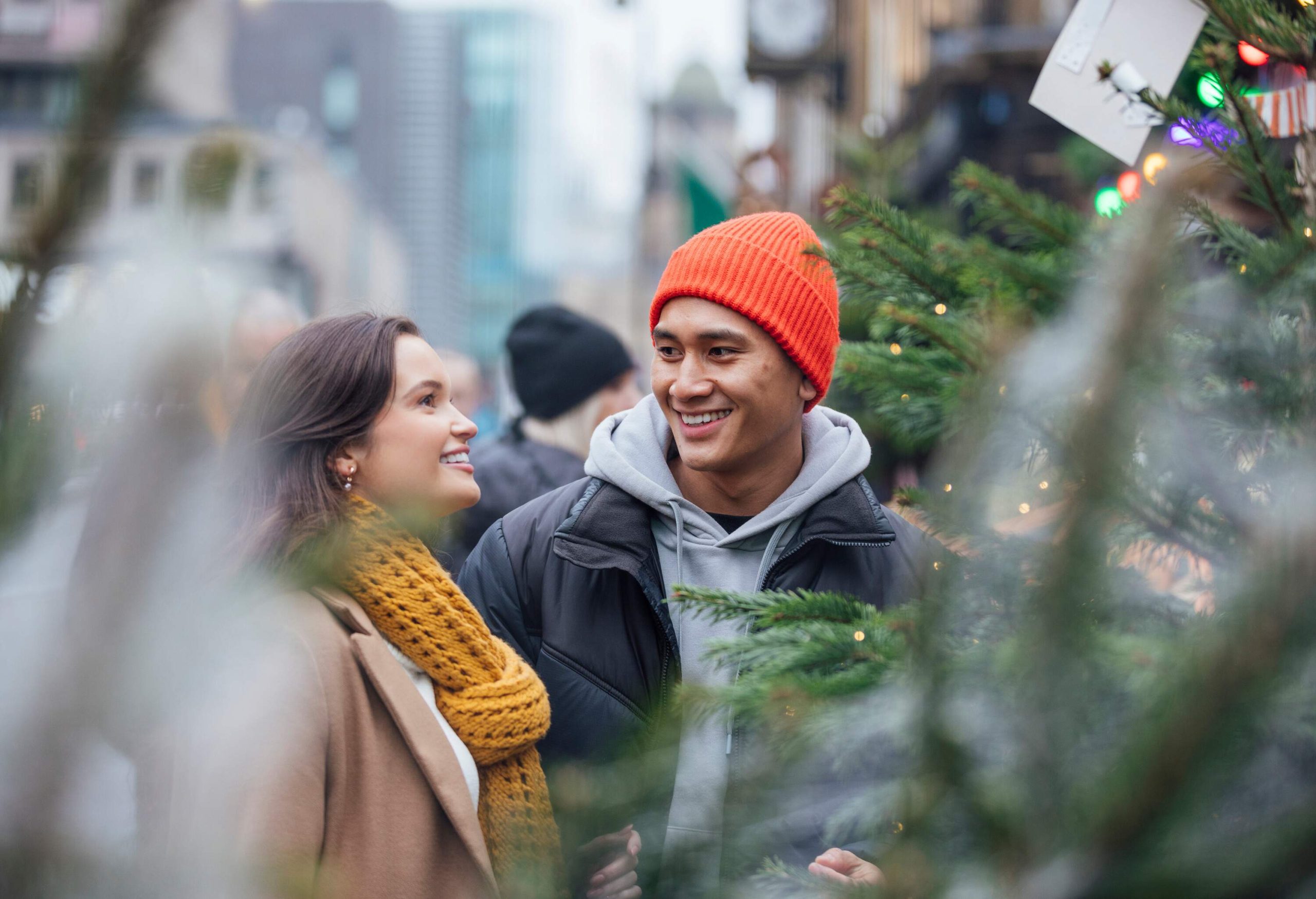 In the heart of Newcastle upon Tyne's Christmas market, a couple's joy shines as they select their very first Christmas tree together. Amidst the twinkling lights and festive charm, their laughter and shared excitement create a magical moment filled with the promise of new traditions and cherished memories.