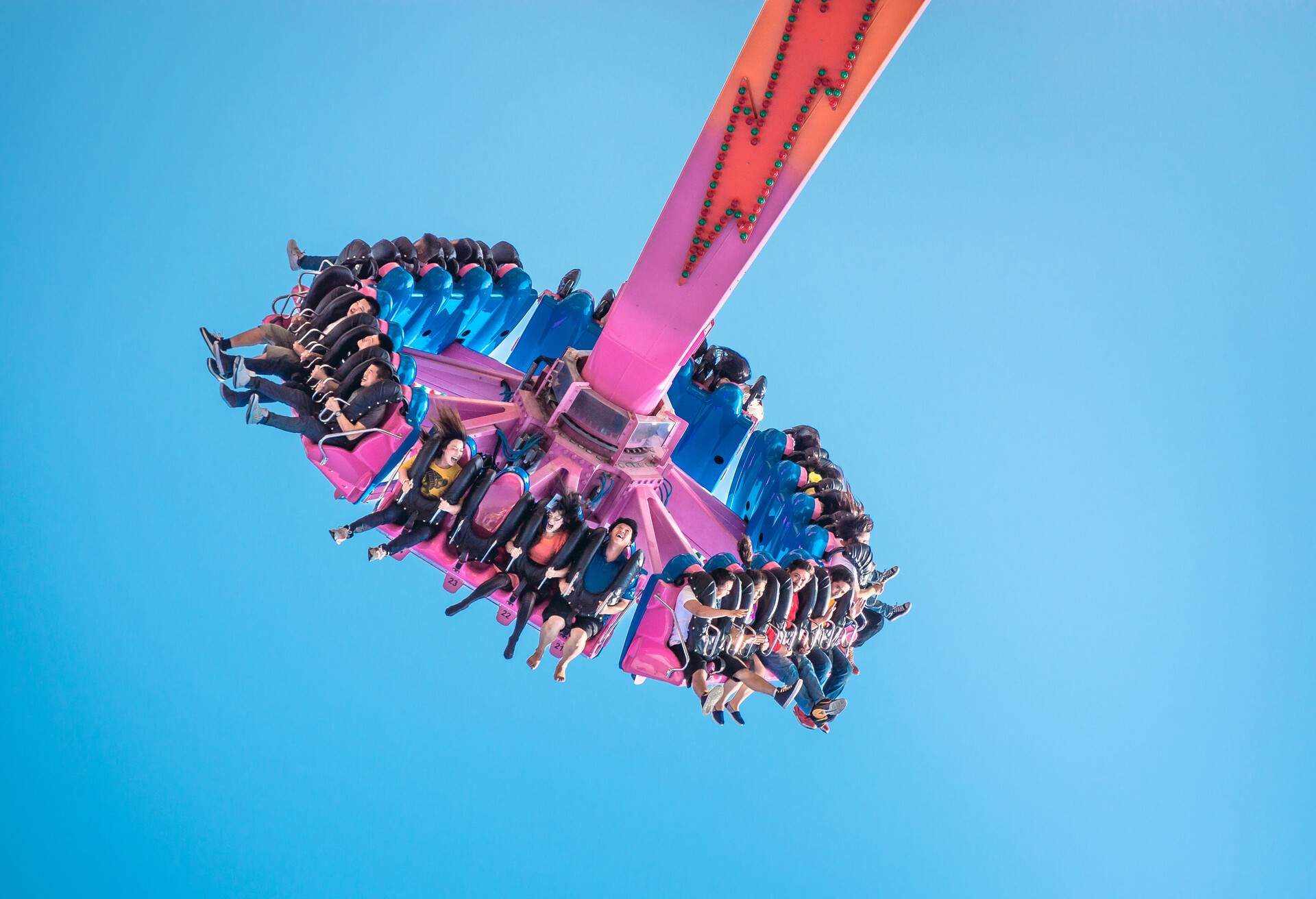 Tourists and locals are having fun on The Flash ride in theme park.