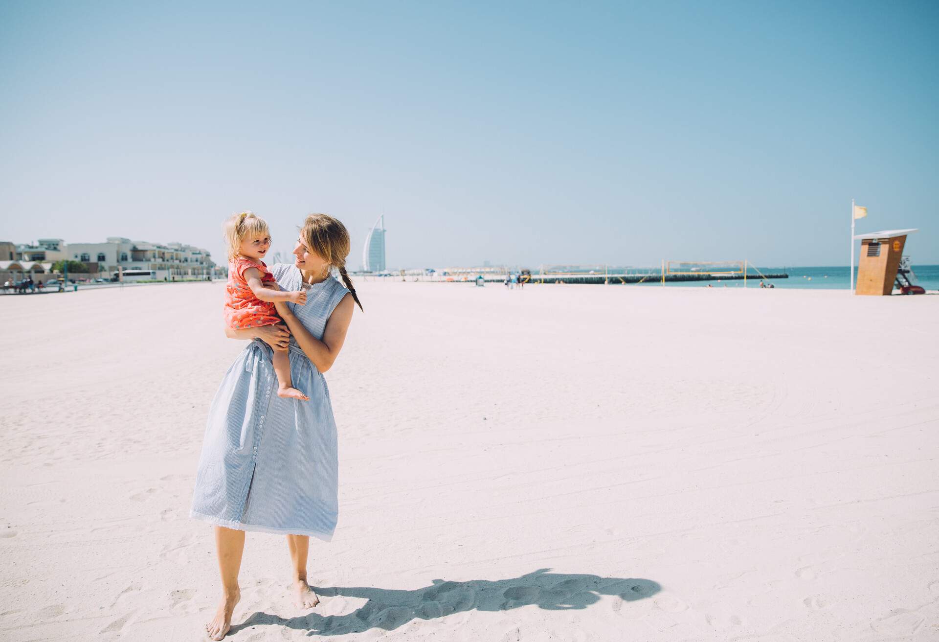 mother and child walking along the beach in Dubai