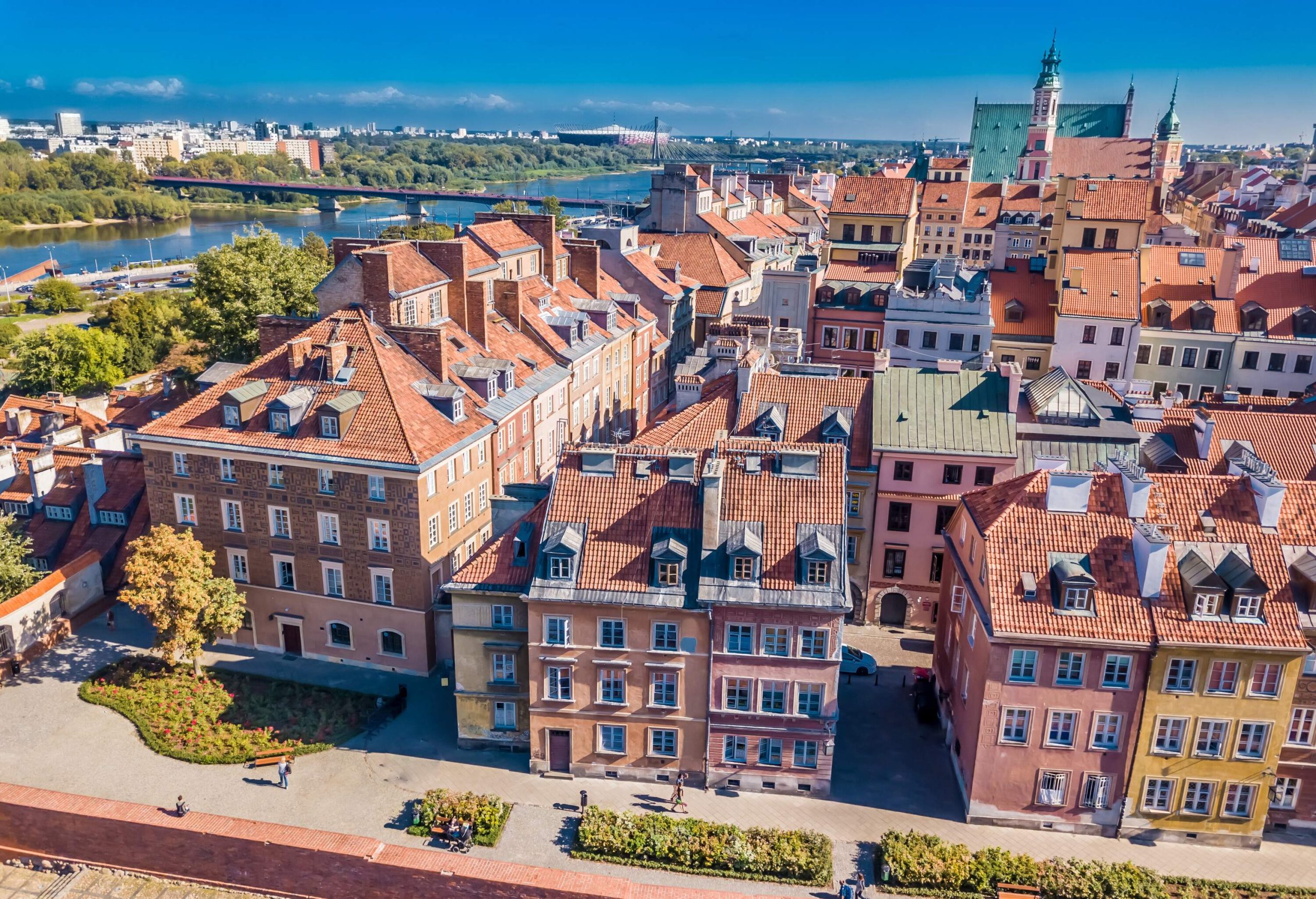 The clusters of compact buildings on the river bank linked through a bridge.