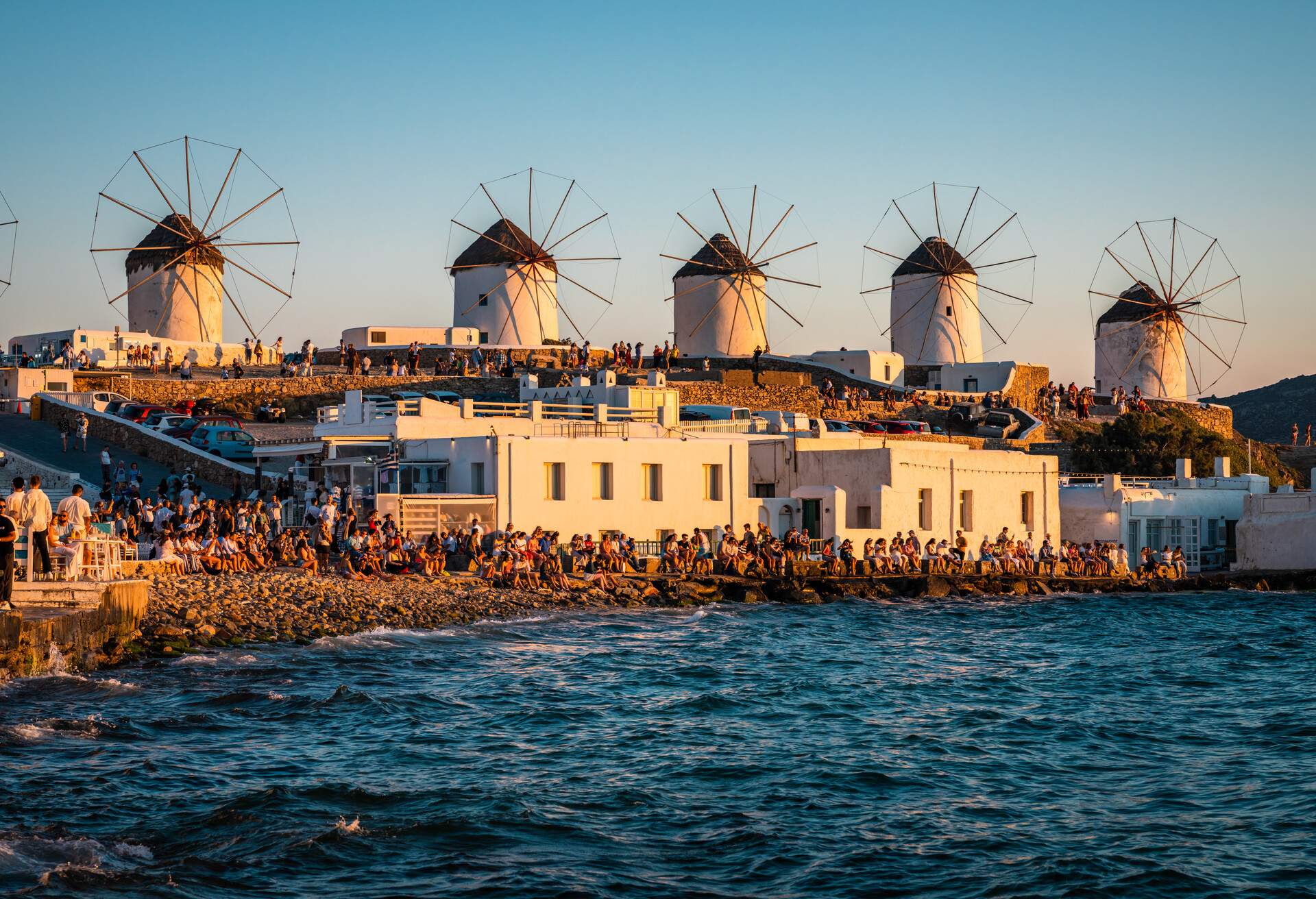 DEST_GREECE_MYKONOS_SUNSET_CROWD_GettyImages-1434359984