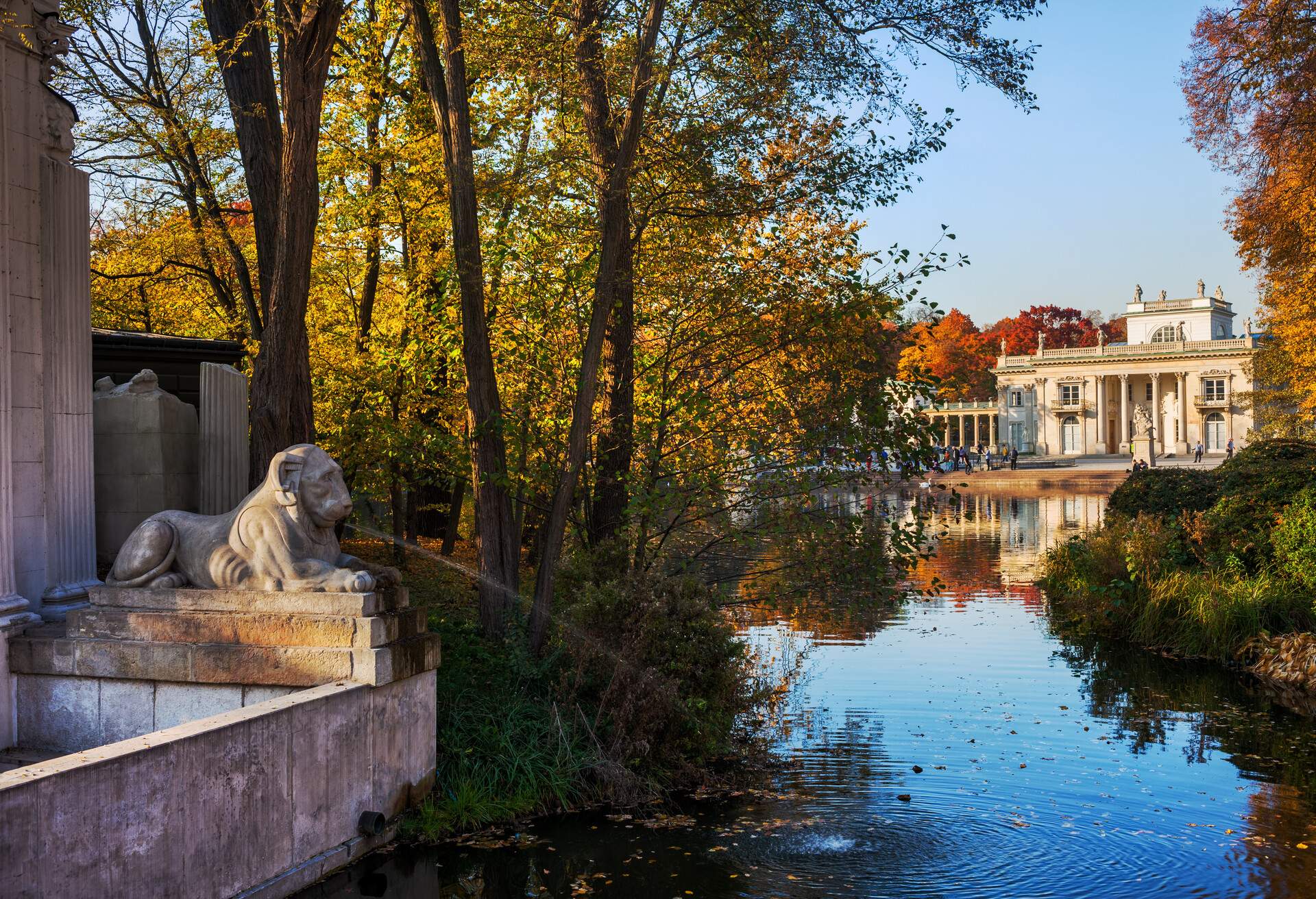 Lazienki Park in Warsaw, Poland, Royal Baths Park with lake and autumn trees, Palace on the Isle (Palace on the Water) from 17th century at the far end.