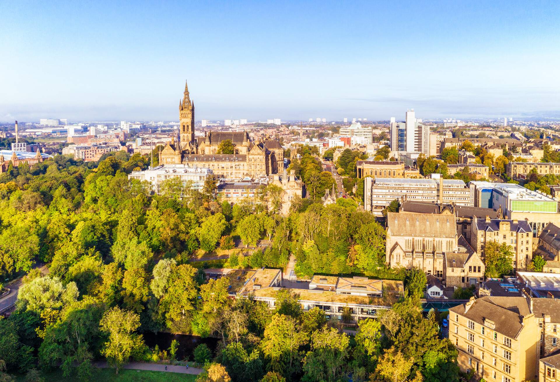 An aerial view of part of Glasgow's West End, including the trees of Kelvingrove Park and several Glasgow University buildings.