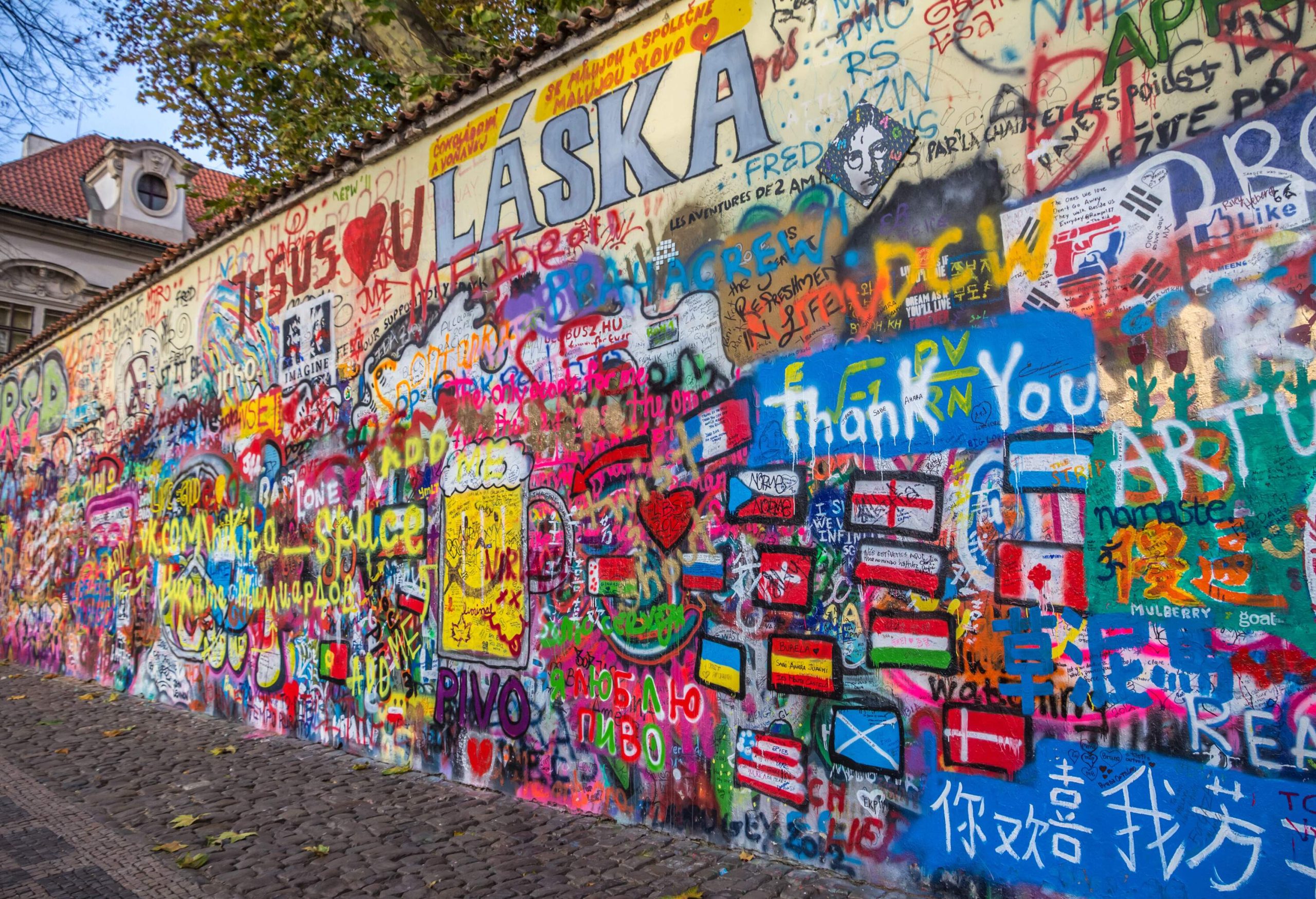 A wall painted with colourful art and graffiti.