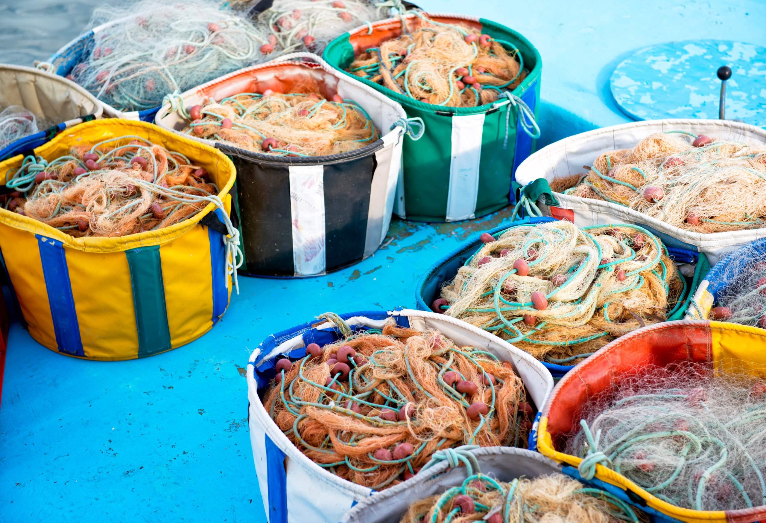 A collection of colourful baskets loaded with fishing nets.