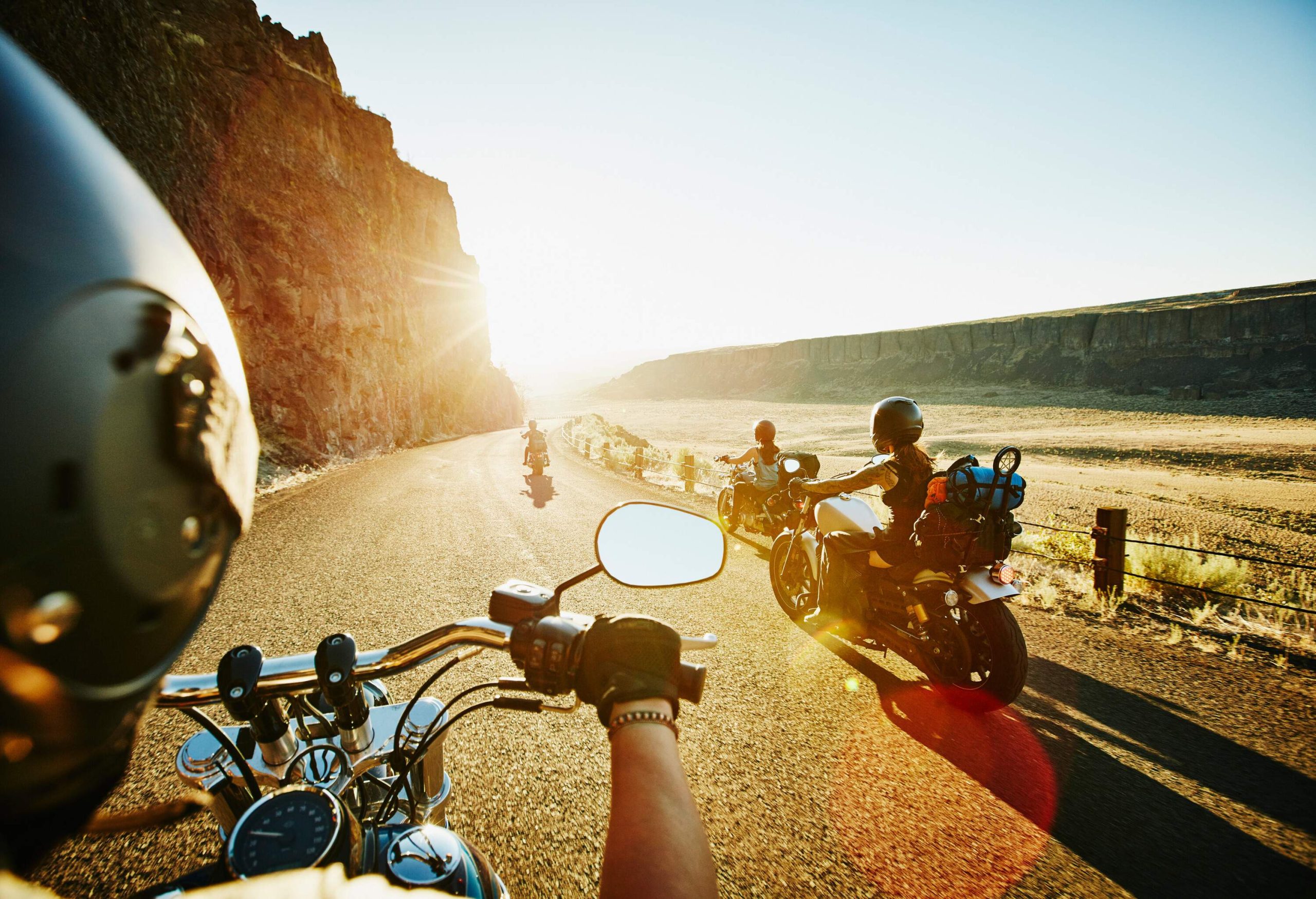 A group of female motorcyclists with their big bikes on a road trip.