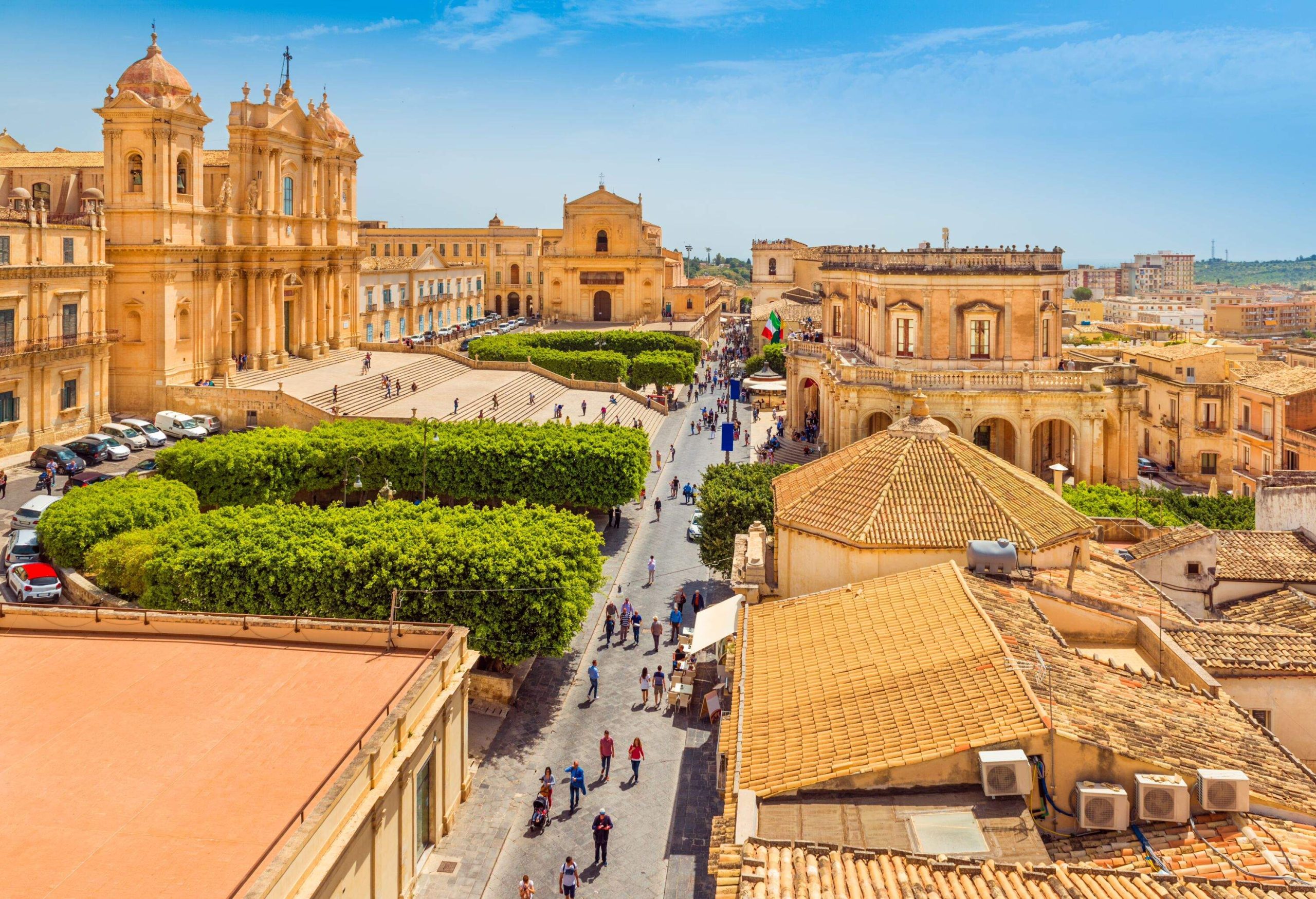 Cityscape of Noto. View of the central street with walking tourists. Province of Syracuse, Sicily, Italy