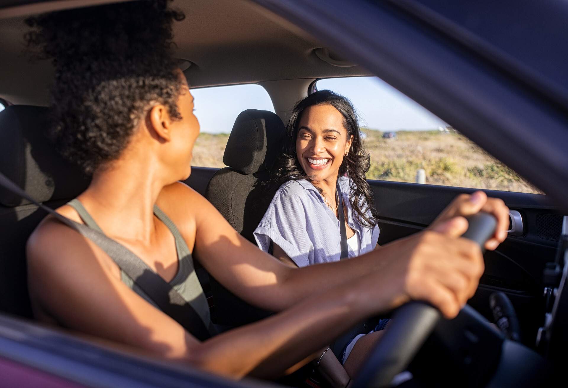 Two friends having fun during a car ride.