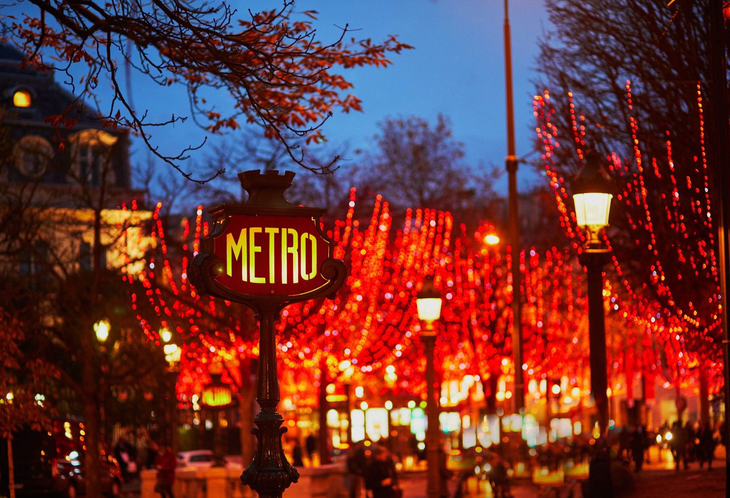 Subway station sign and seasonal holiday illumination on Champs Elysees street in Paris, France. Celebrating Christmas and New Year in French capital