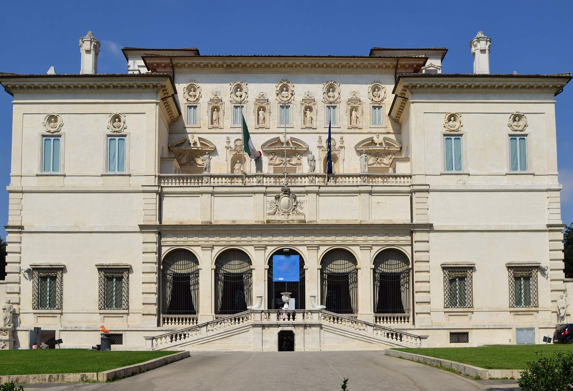 A stunning baroque-style building features a symmetrical design adorned with columns, pilasters, and other decorative elements.