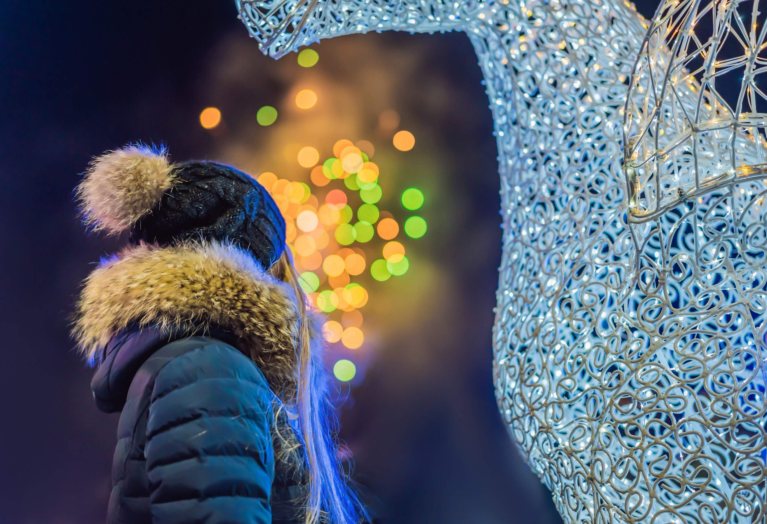 Woman looking at christmas sculpture.