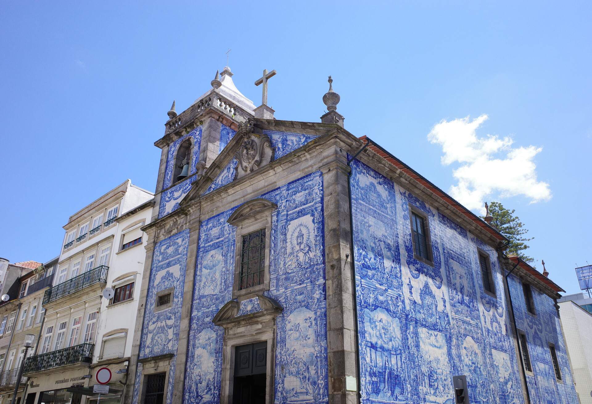 A stunning stone church beautifully embellished with vibrant and intricate azulejo tiles.