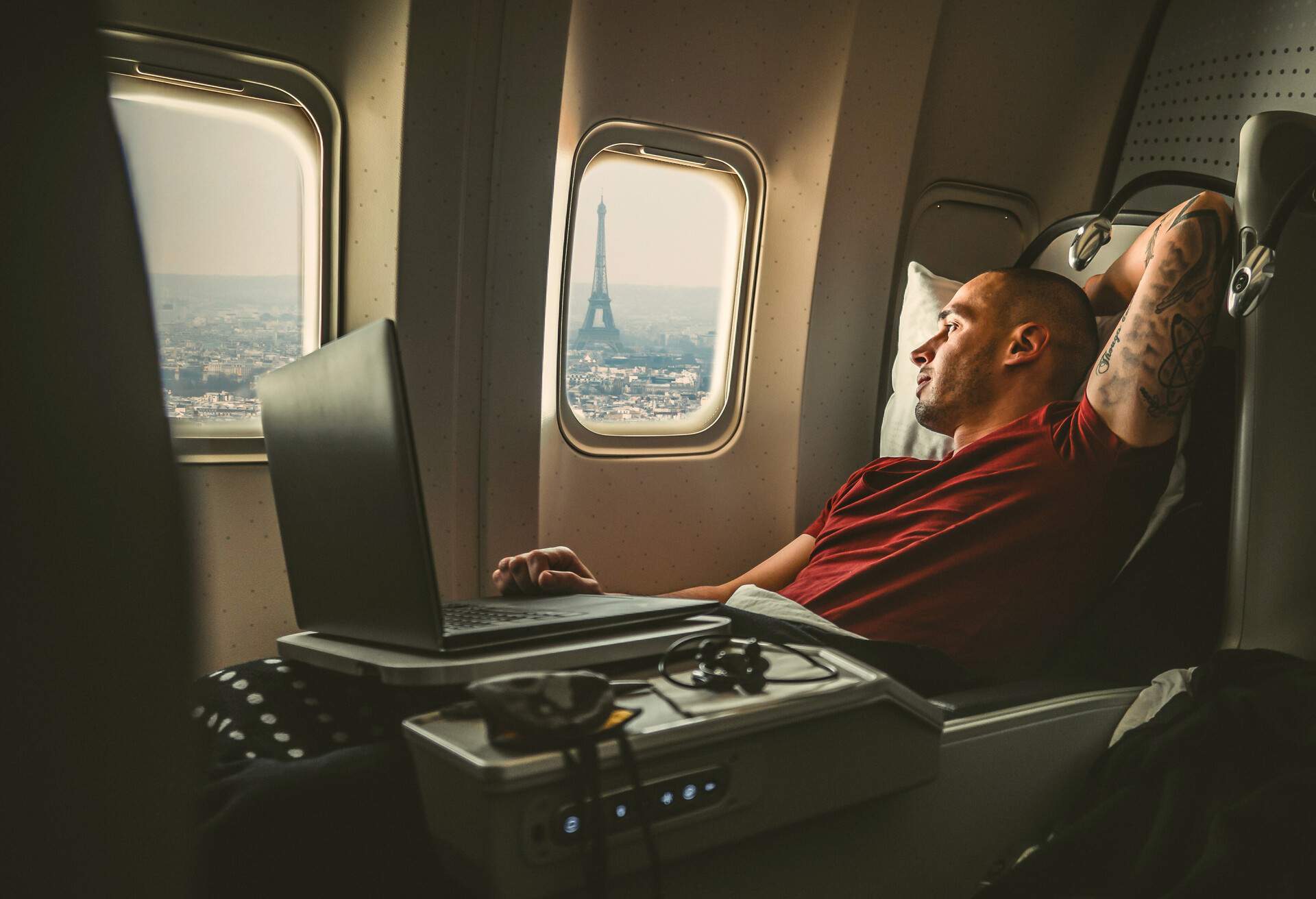 dest_france_paris_theme_plane_device_man_laptop_gettyimages-1263553498_universal_within-usage-period_82131.jpg