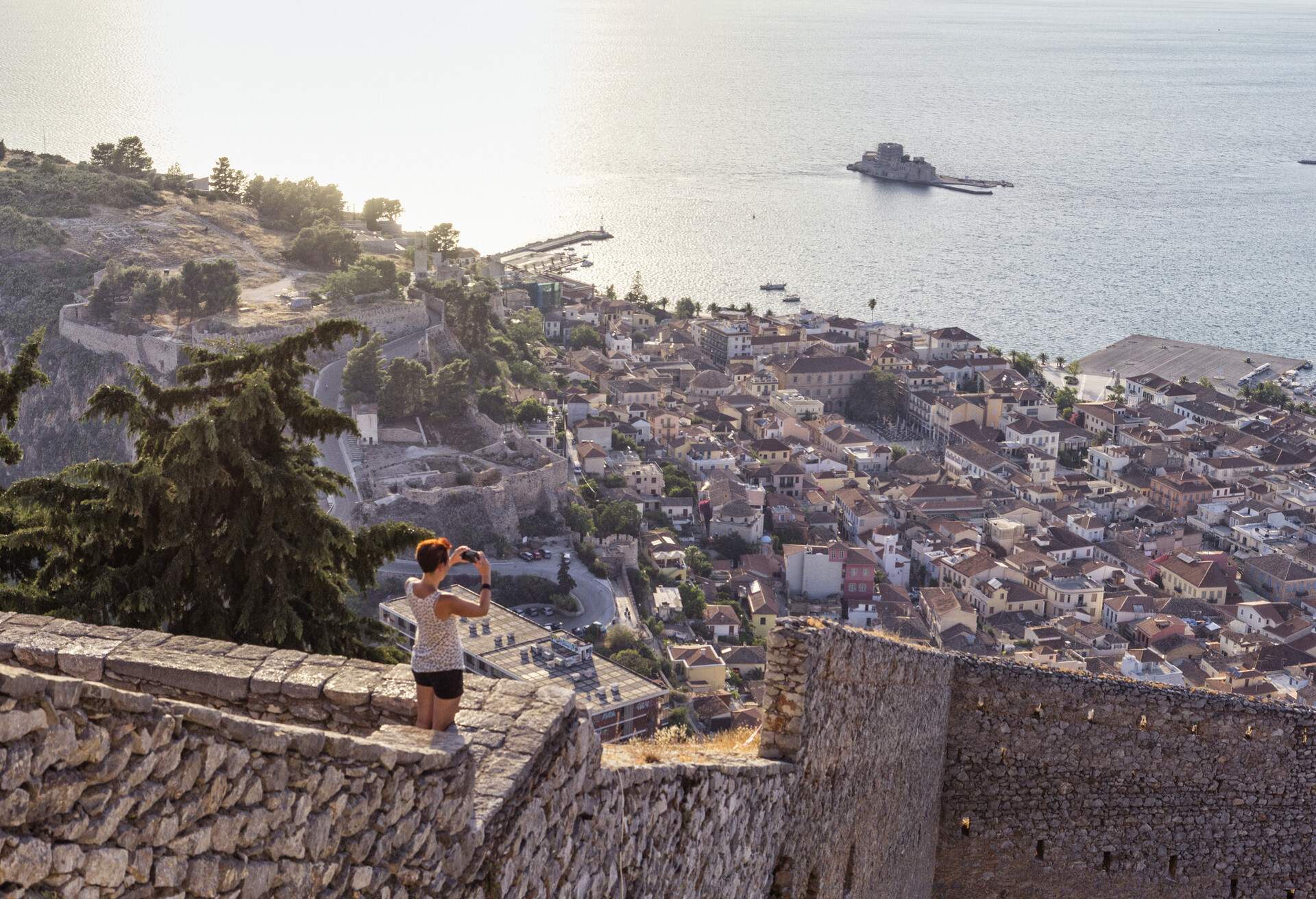Greece, Peloponnese, Argolis, Nauplia, Argolic Gulf, person photographing view to Bourtzi Castle