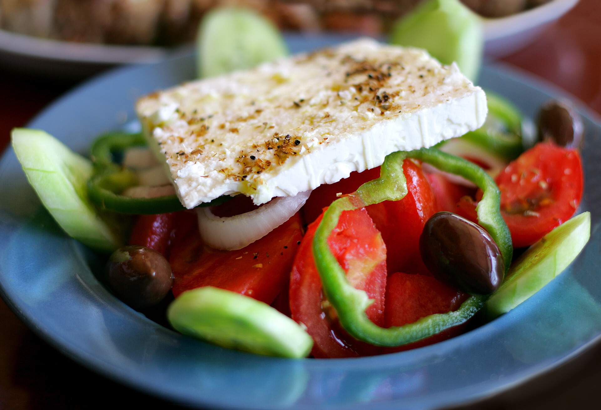 Greek Salad, dish of traditional Greek village salad with fetta cheese, olives, pepers, cucumber, tomatoes and peppers, origano, olive oil and vinegar.