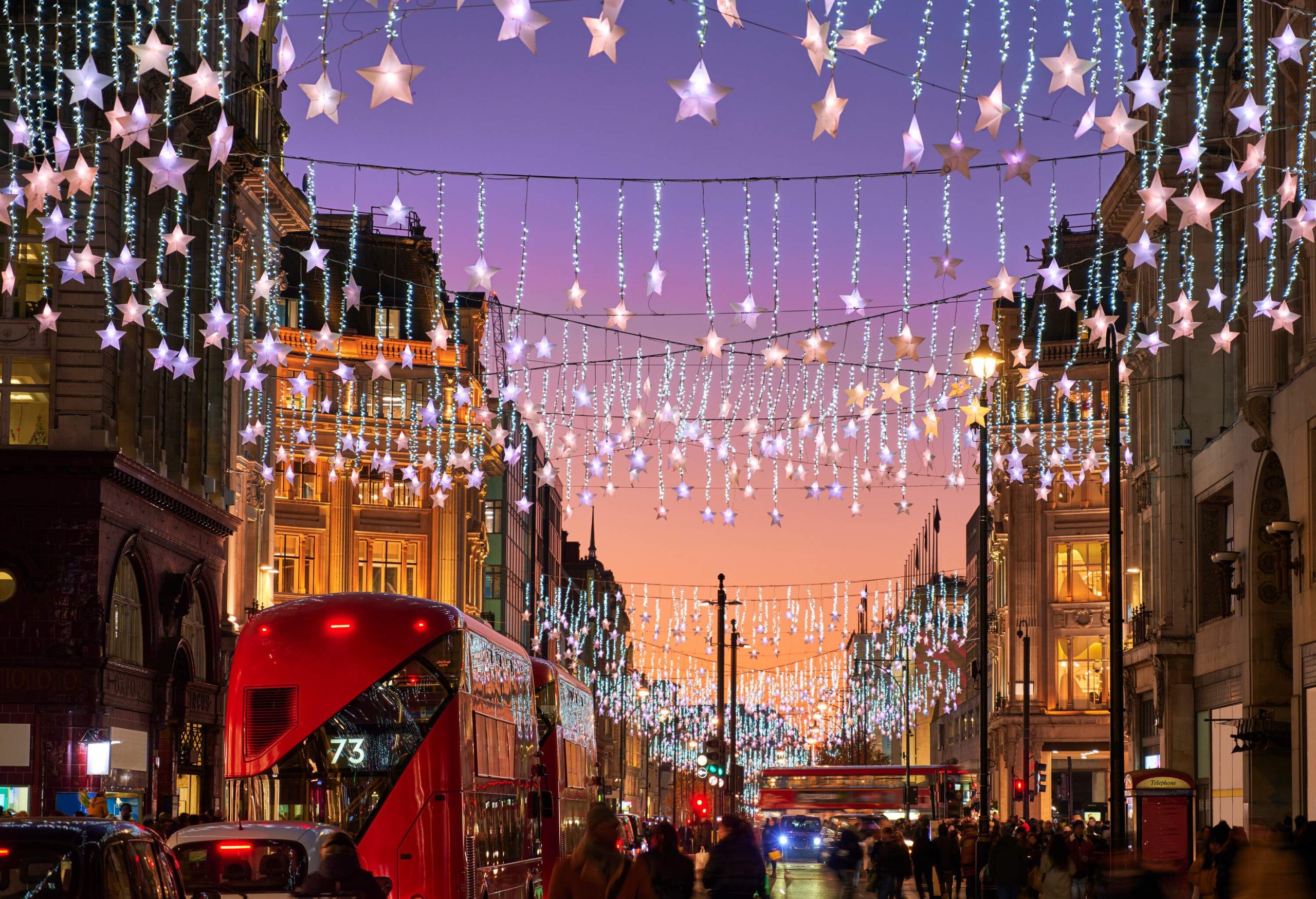 UK, London, Oxford Street, busy street at Christmas with lights at dusk
