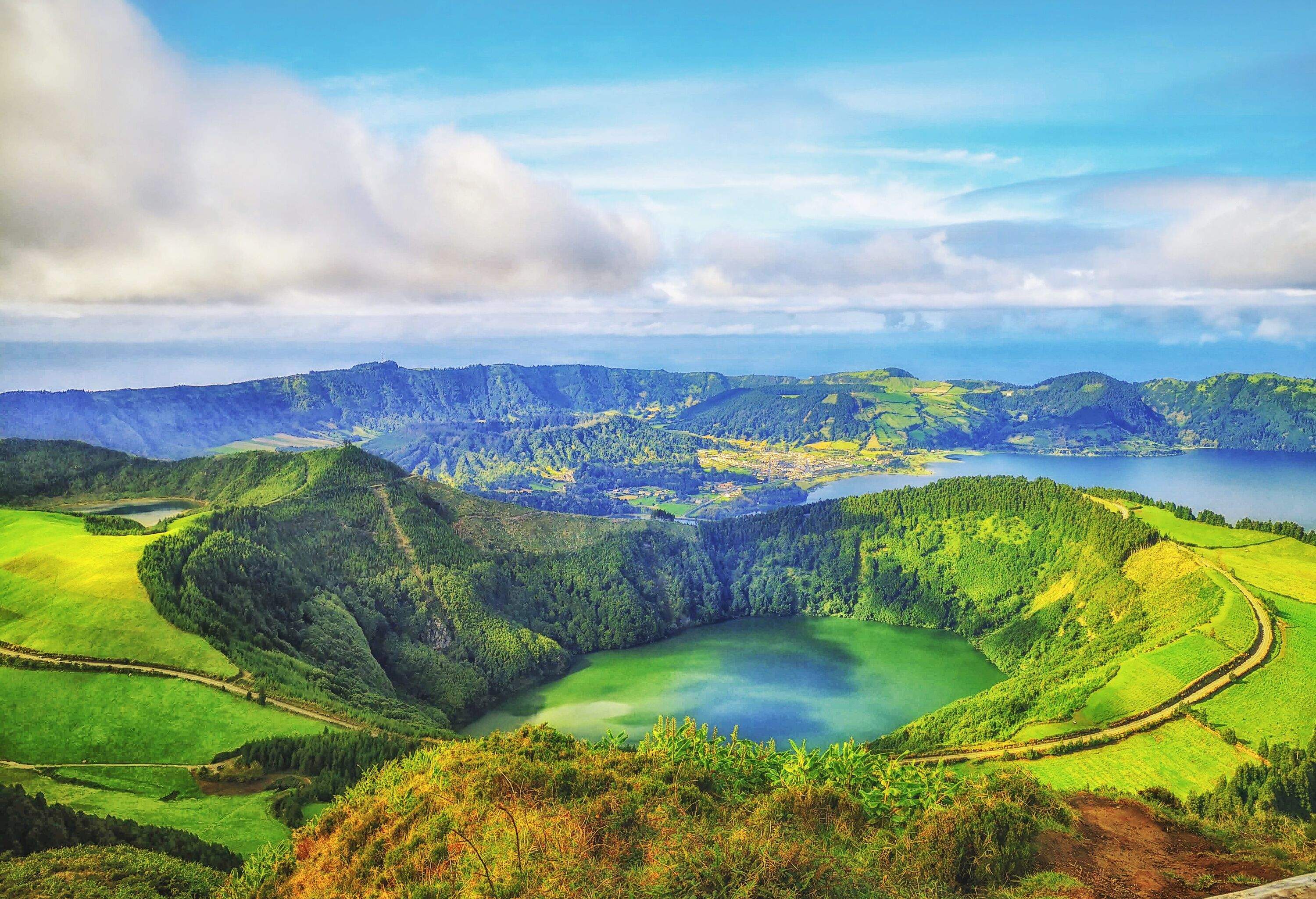 Lagoa das Sete Cidades is a lake in a crater of a dormant volcano surrounded by slopes covered in dense vegetation.