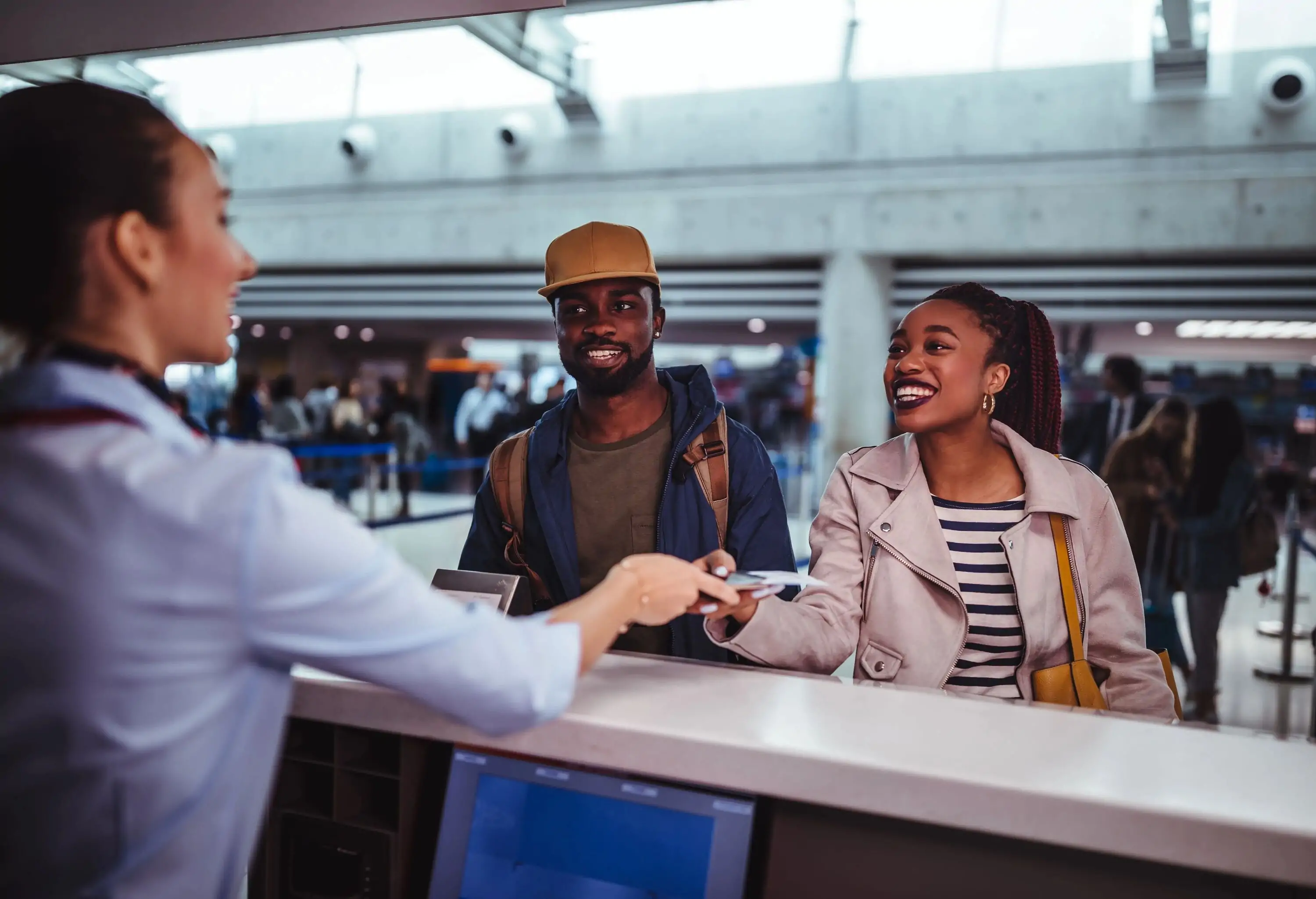 A couple at the airport checking in their baggage