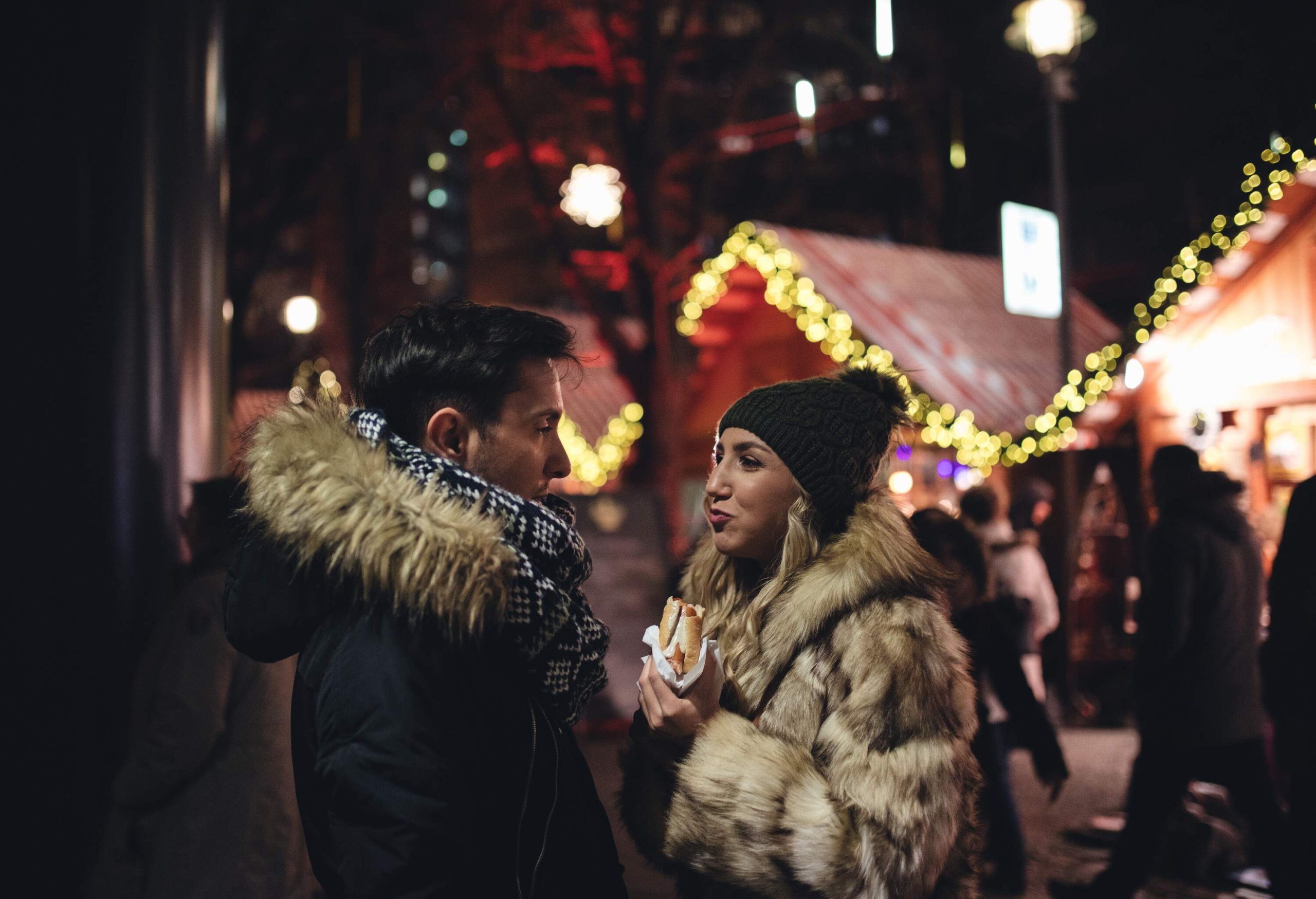 Cheerful couple in love enjoying Christmas market