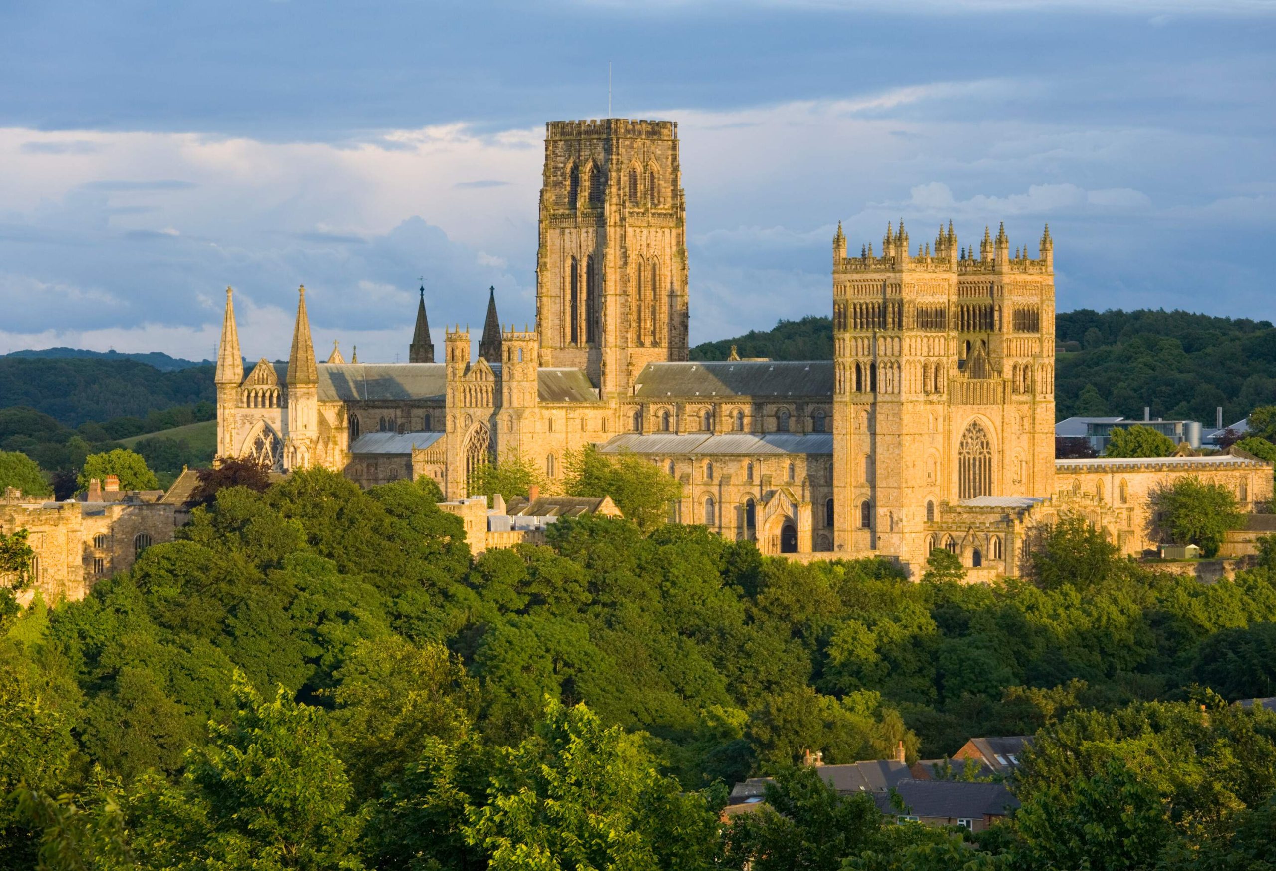 The impressive Durham Castle and Cathedral emerging from the surrounding hills and trees.