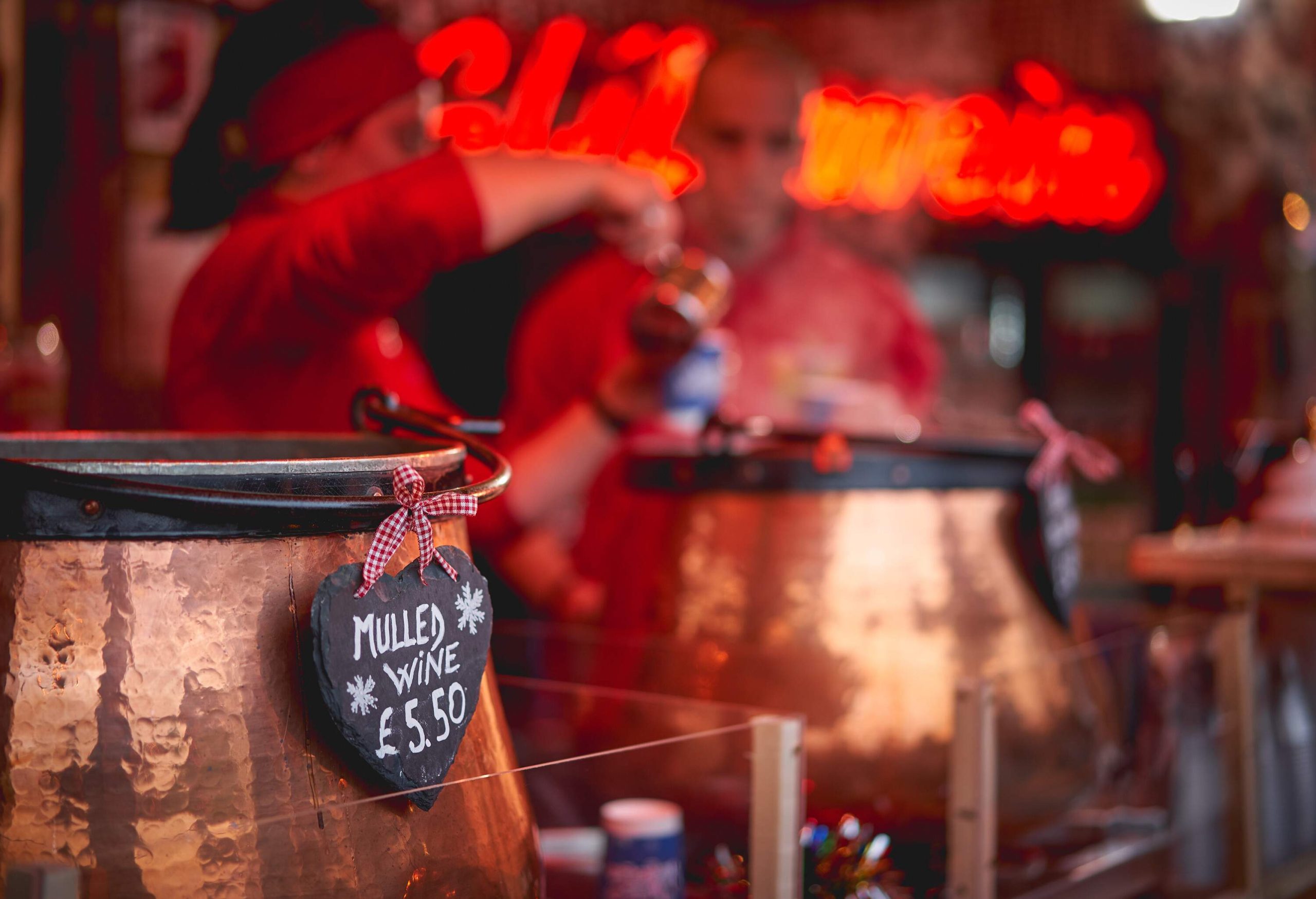 Pots of mulled wine in a stall in a Christmas market. 