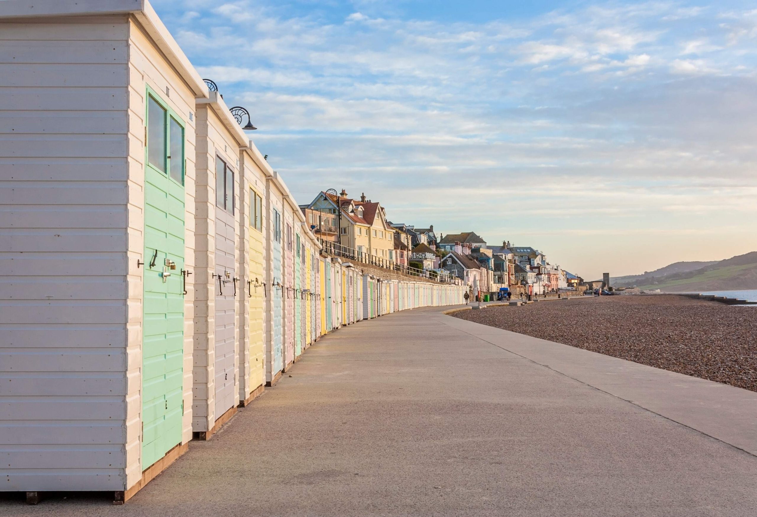 Pastel-coloured beach huts form a vibrant and inviting line along the promenade.